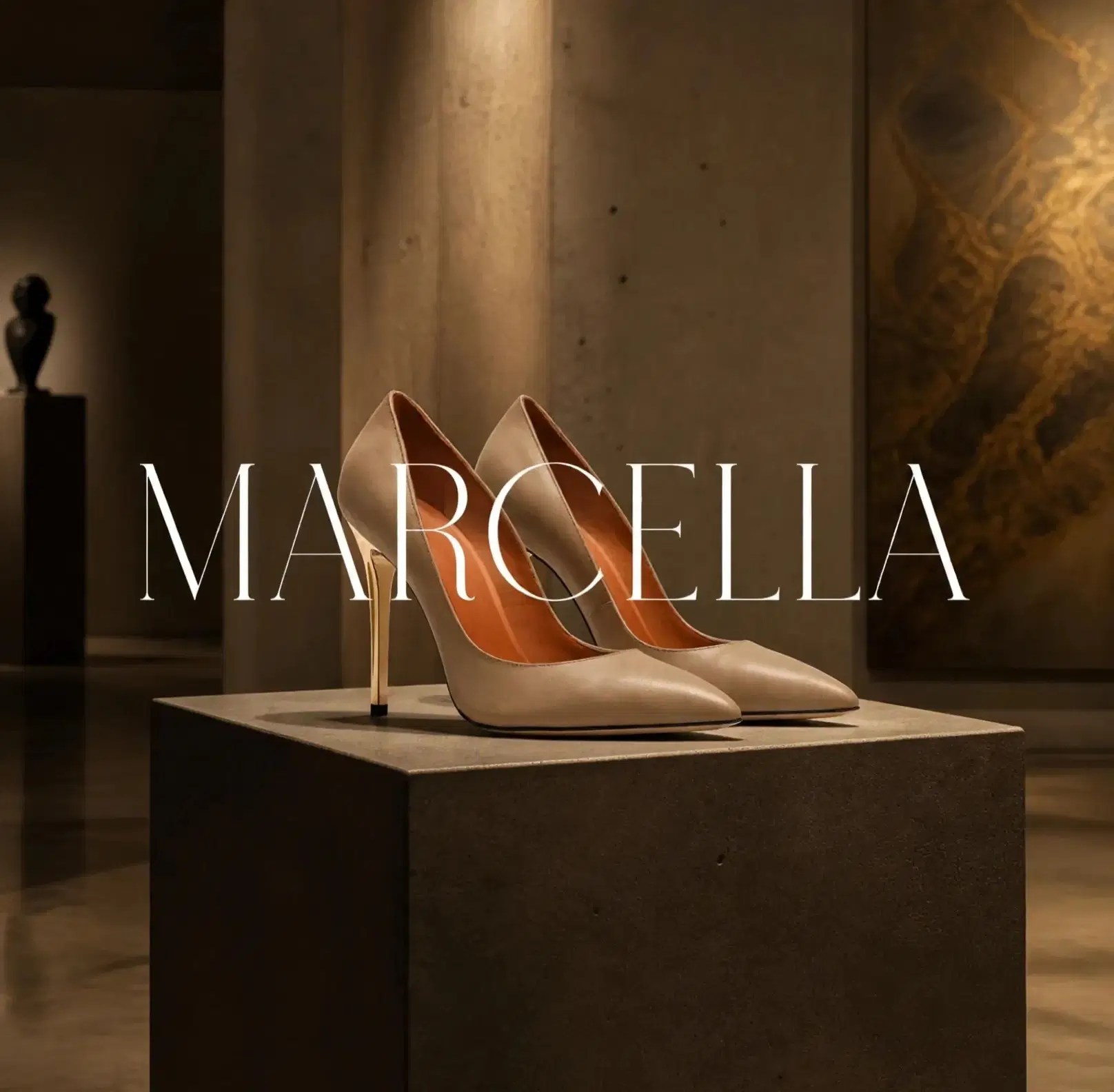 Beige Marcella stilettos displayed on a stone pedestal in a gallery interior