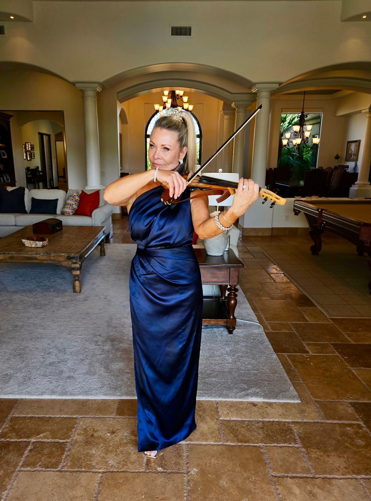 Carrie Caruso performing in an elegant navy gown in an upscale residence