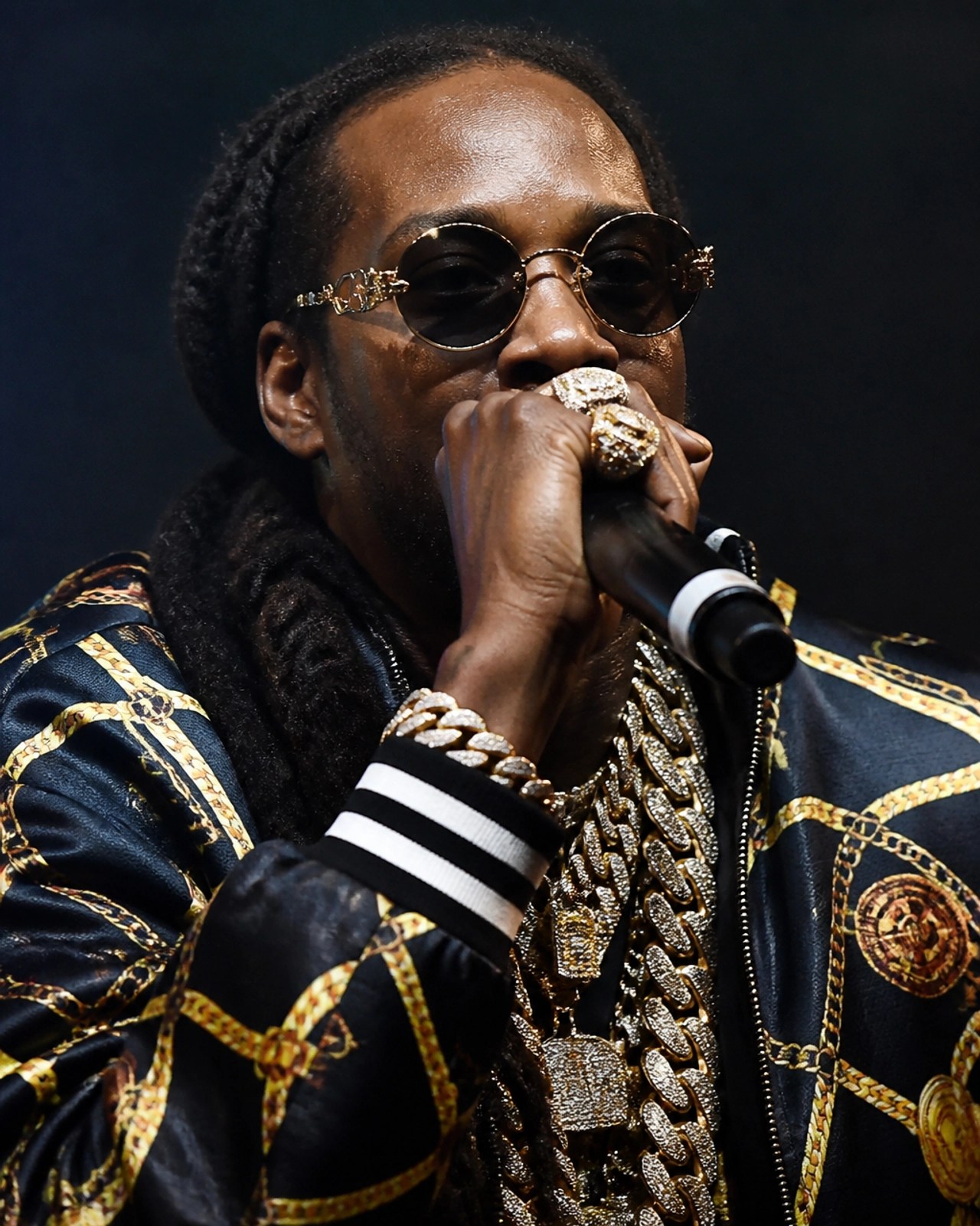 2 Chainz performing with heavy jewelry and dramatic stage lighting
