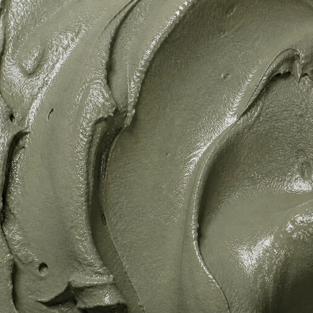 A high-detail close-up texture of wet, smooth French green clay