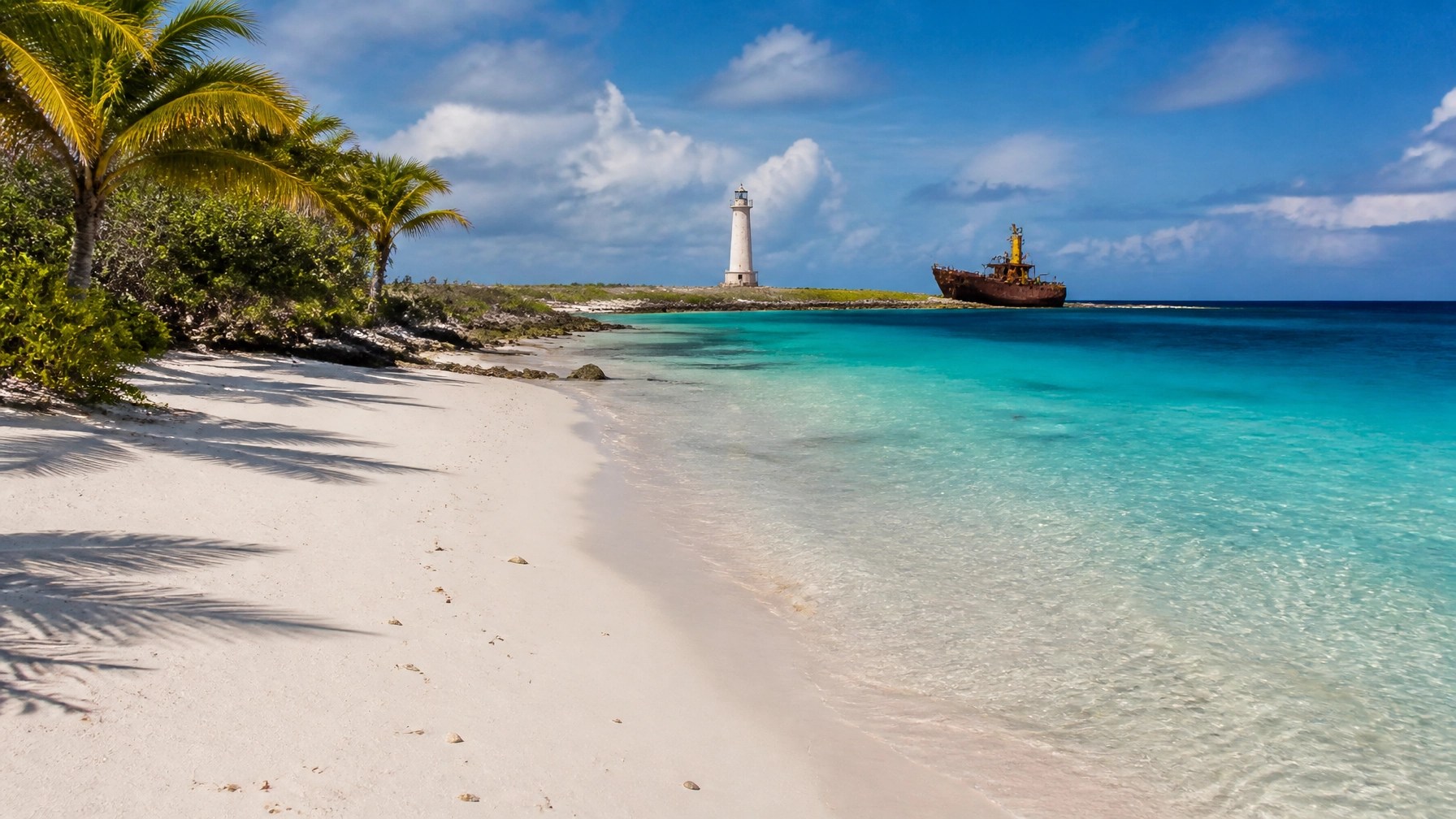 Klein Curaçao with a pristine white-sand beach, turquoise water, lighthouse, and quiet tropical scenery