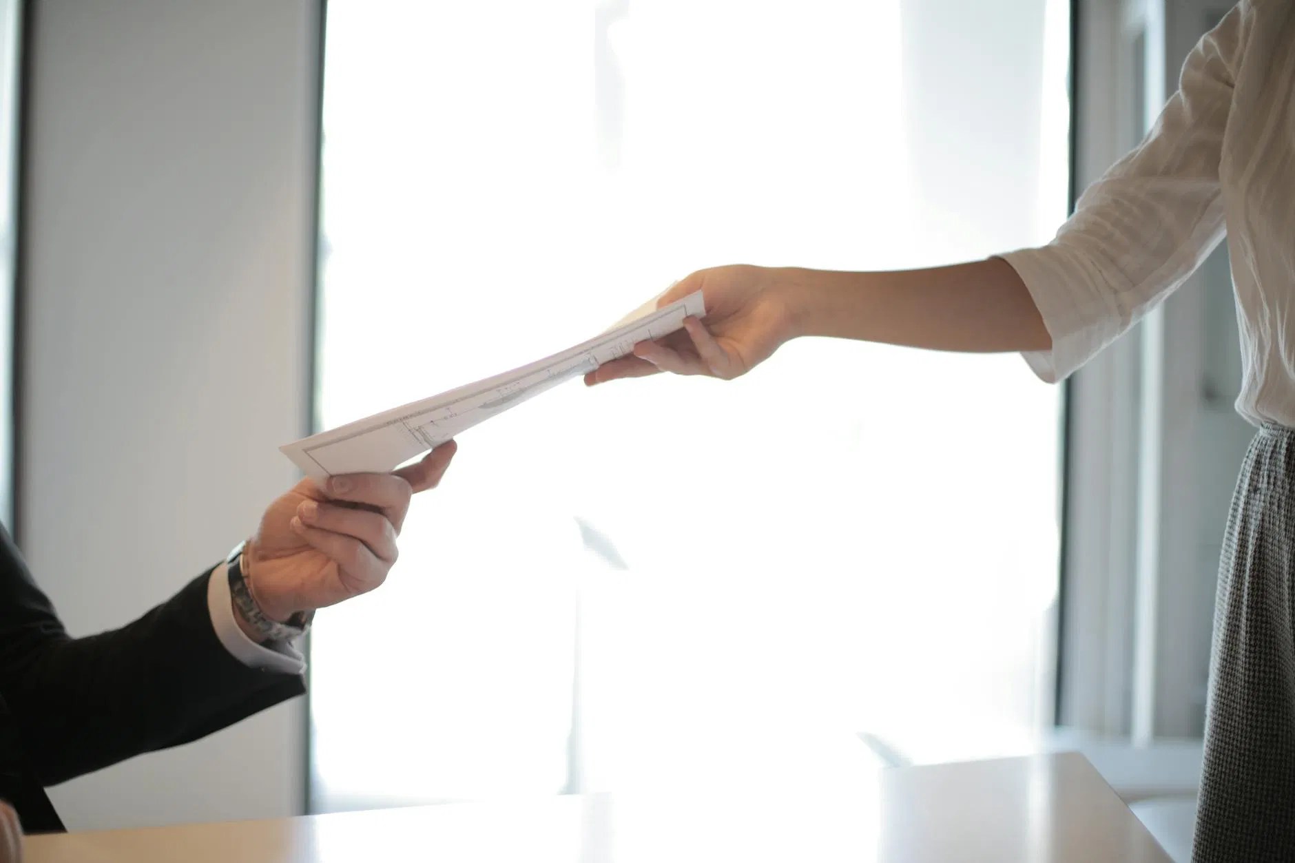 Professional document handover representing contract management