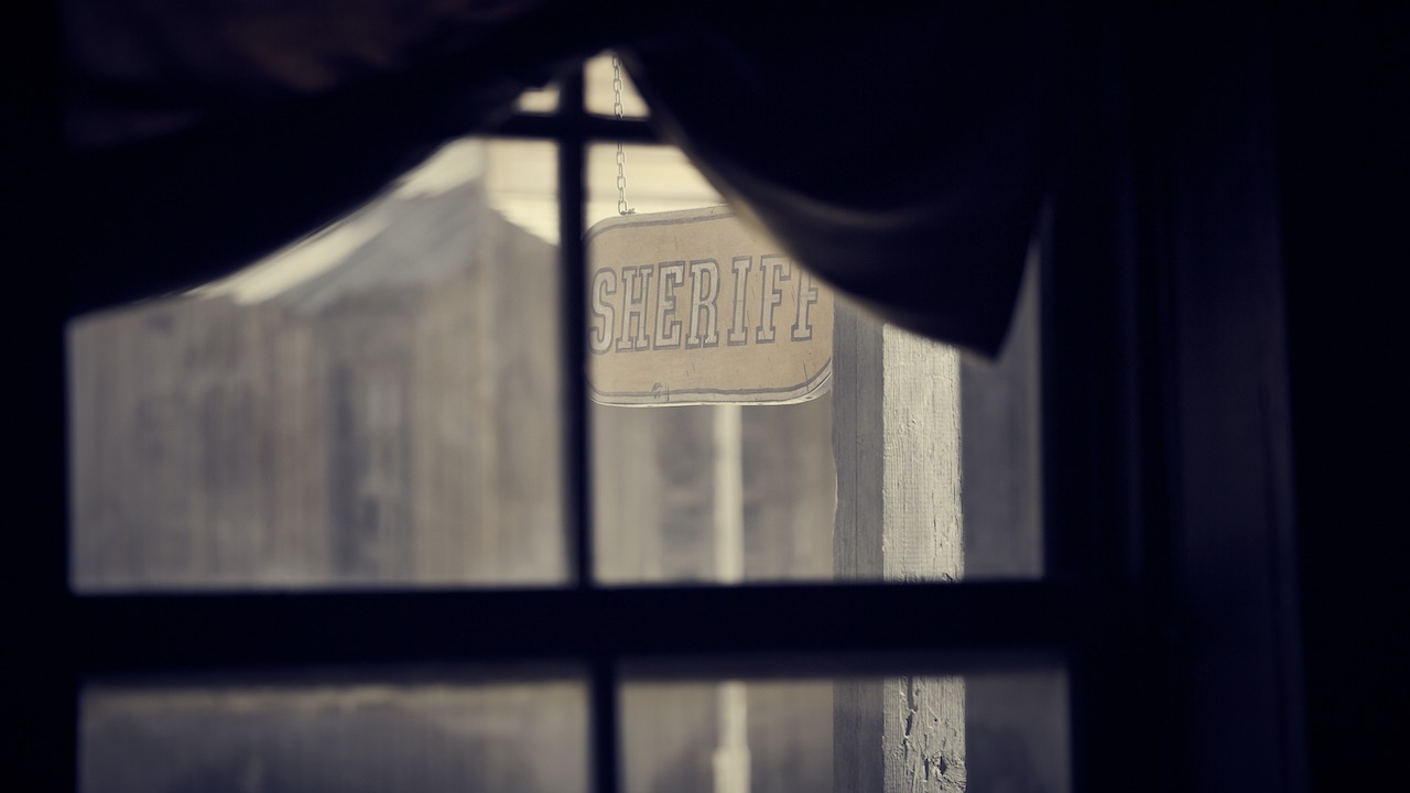 Sheriff Sign through a window