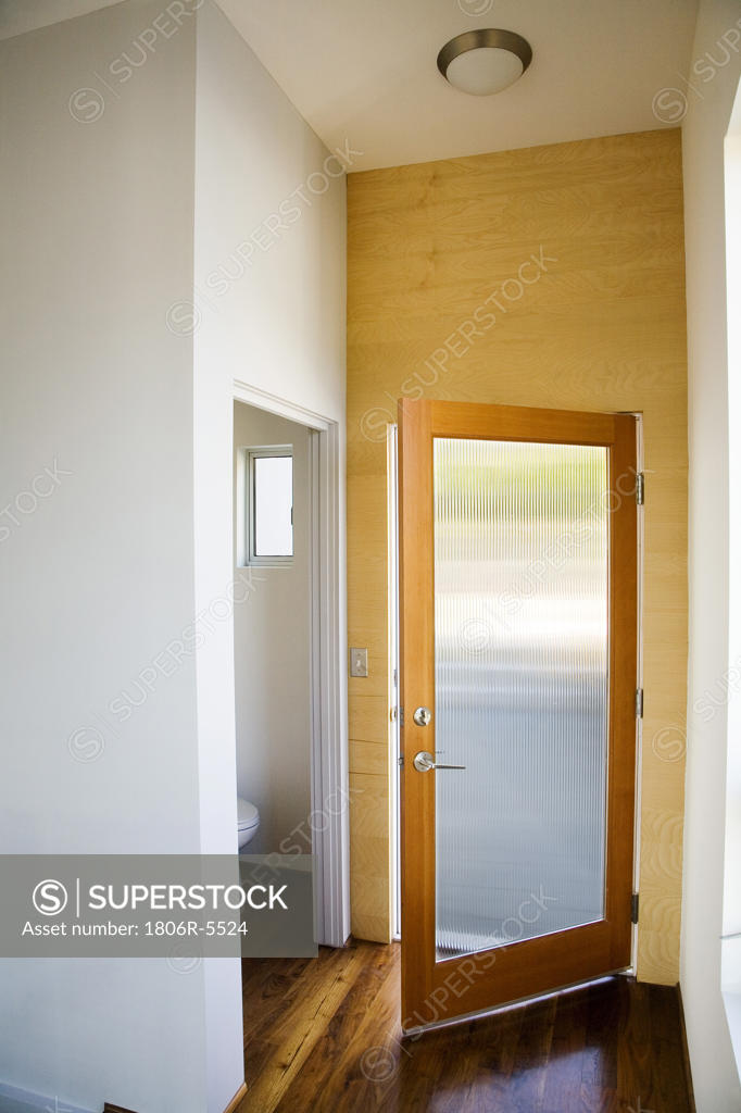 Improve your home's curb appeal simply by painting your front door a new color. Open Frosted Glass Front Door Stock Photo 1806R-5524