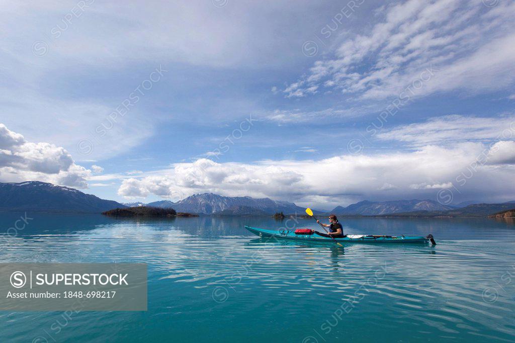 British style or greenland style and north american style. Young Woman In A Sea Kayak Paddling Sea Kayaking Mountains Behind Tagish Highland Atlin Lake British Columbia Canada America Stock Photo 1848 698217 Superstock