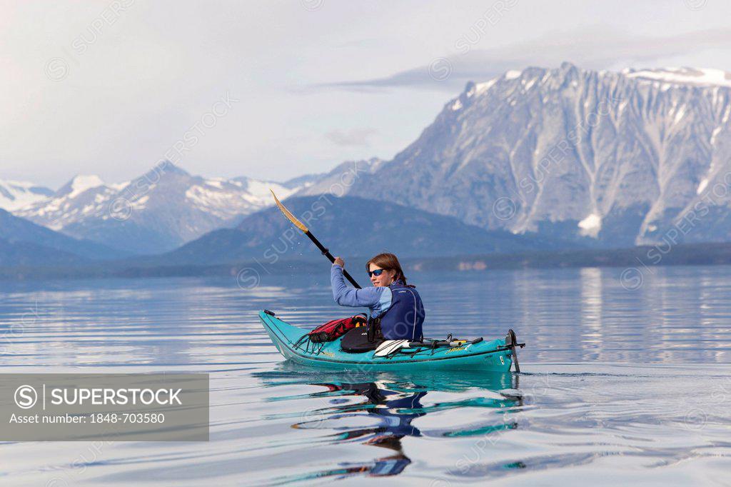 Developed to conquer high winds and confused seas, british style kayaks are a moderate form of performance touring kayak. Young Woman In A Sea Kayak Paddling Sea Kayaking Mountains Behind Tagish Highland Mount Fetterly Atlin Lake British Columbia Canada America Stock Photo 1848 703580 Superstock