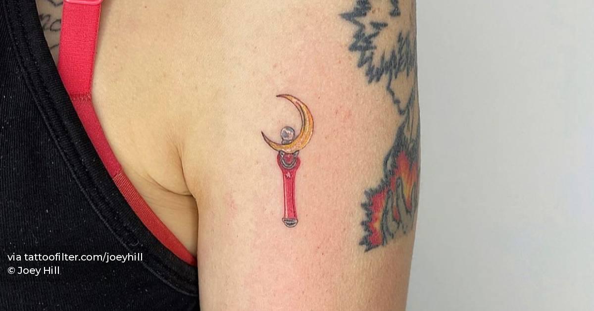 Moon Stick Tattoo On The Upper Arm.