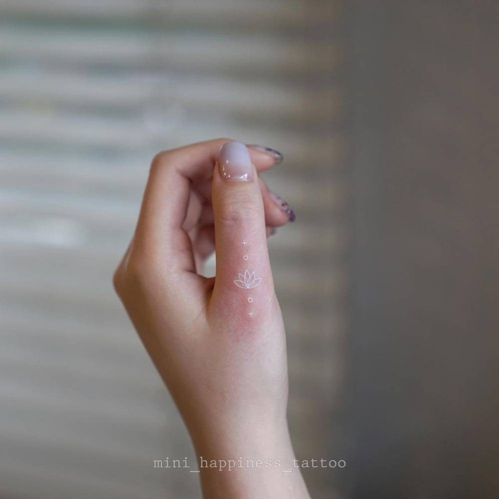 Minimalist White Lotus Flower Tattoo On The Thumb. 1000_x_1000_jpg