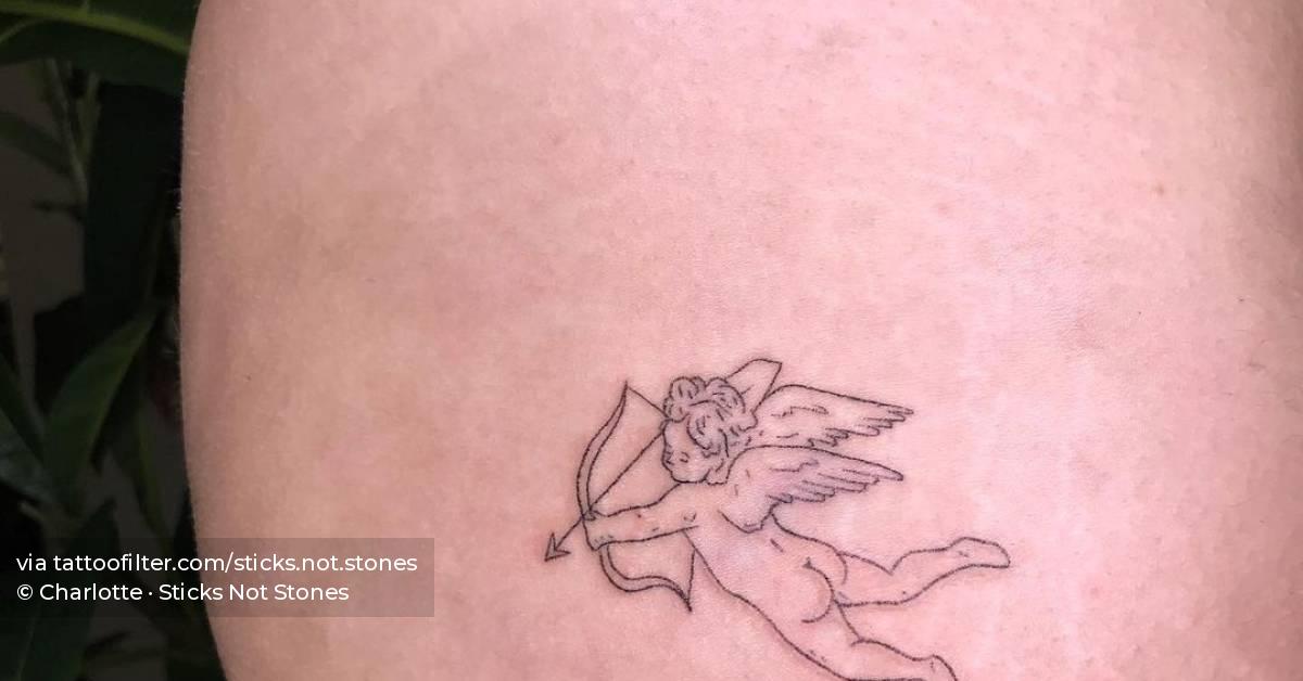 Cheeky Hand Poked Cupid Tattoo Located On The Thigh. 628_x_1200_jpg