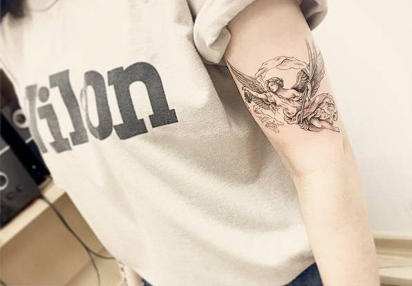 Illustrative Style Angel Tattoo On The Left Upper Arm
