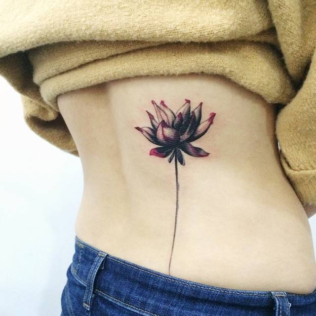 Watercolor Style Lotus Flower Tattoo On The Lower Back. 640_x_640_jpg