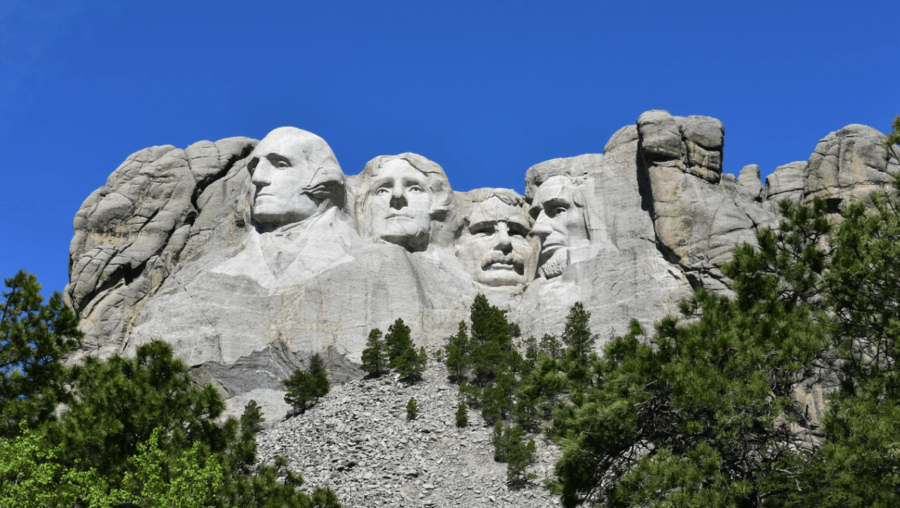 Photograph of Mt. Rushmoore, a granite mountain with 4 presidential profiles etched into it