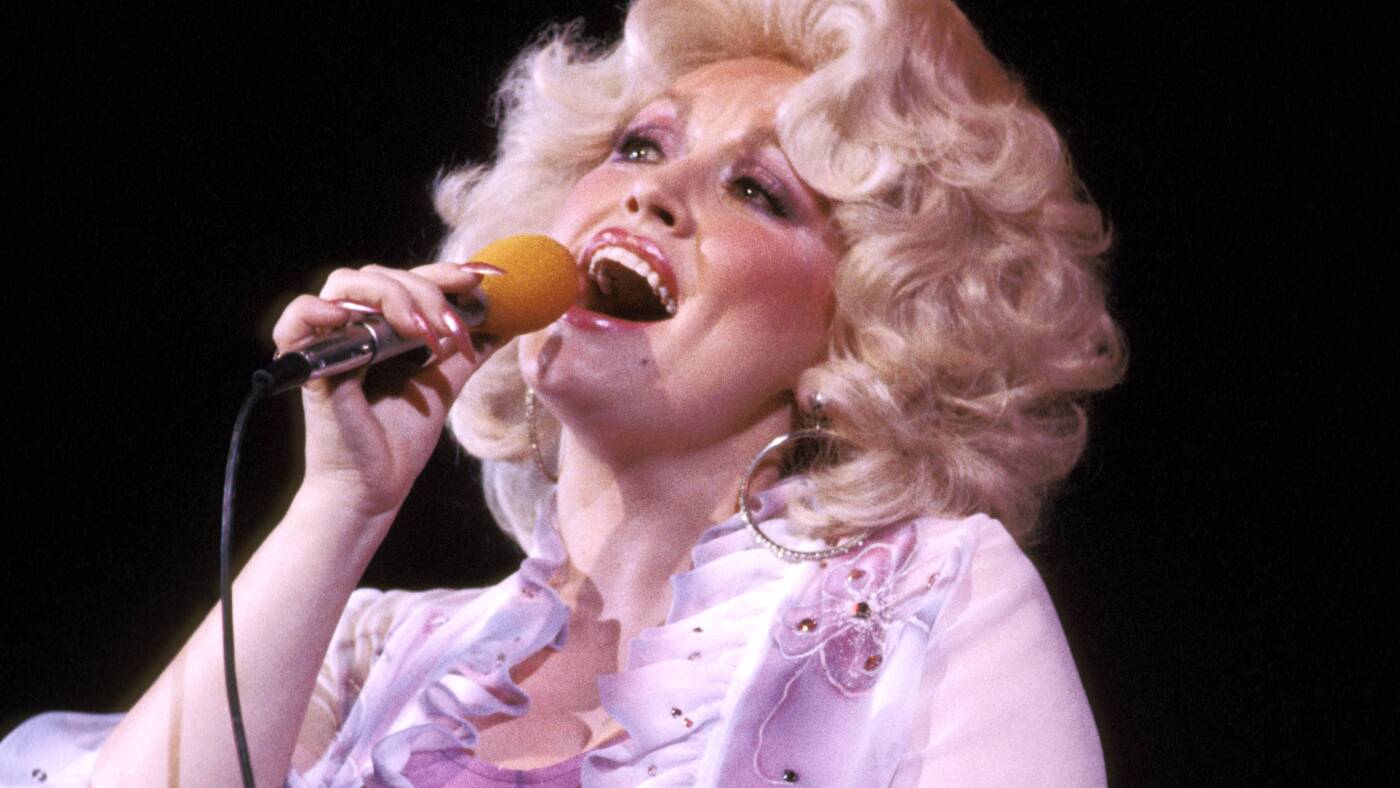 Dolly Parton singing into a microphone