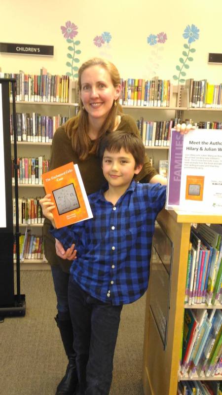 Hilary and Julian Wang at the Multnomah County Library holding their book: The Enchanted Cello Case