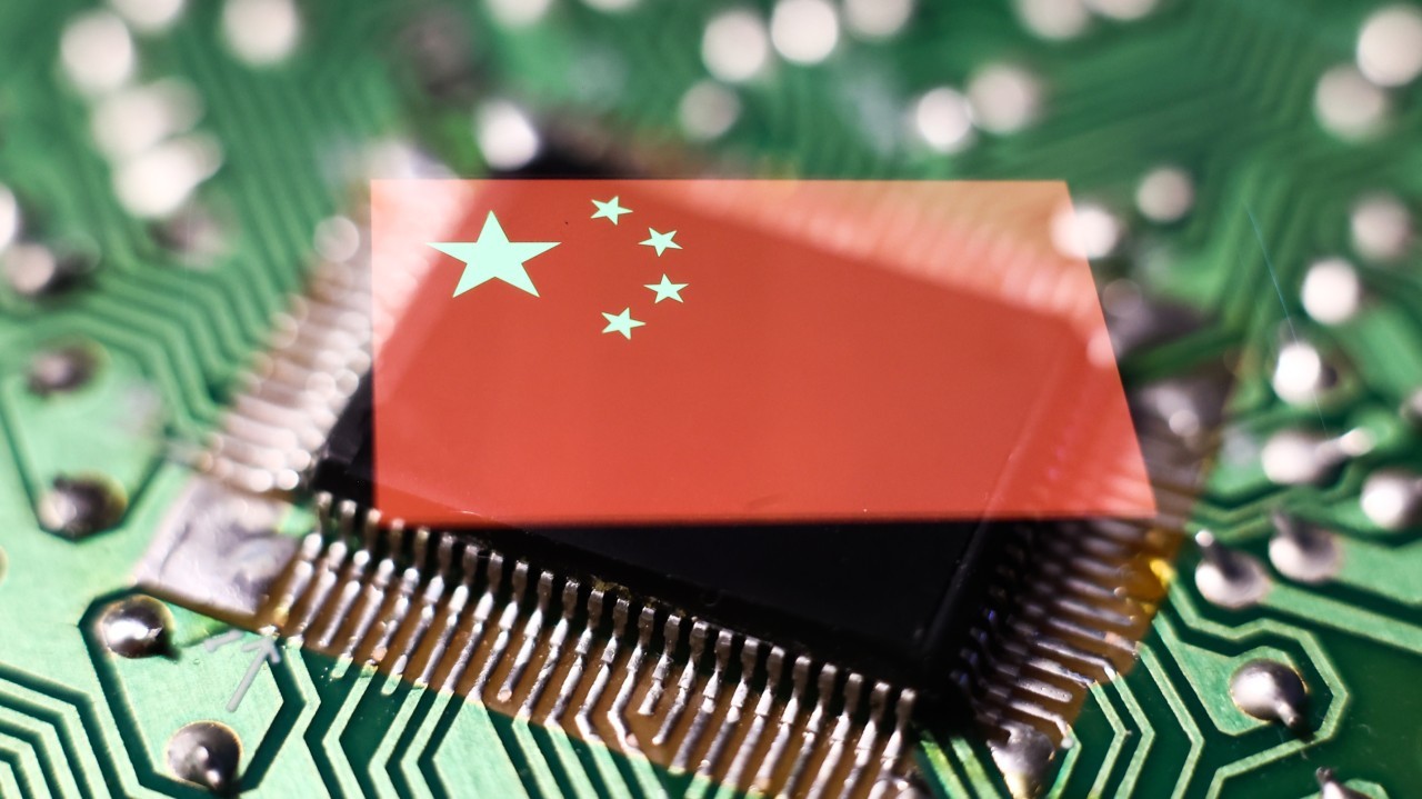 Photo: Microchip and Chinese flag displayed on a phone screen. Credit: Jakub Porzycki/NurPhoto via Reuters Connect.