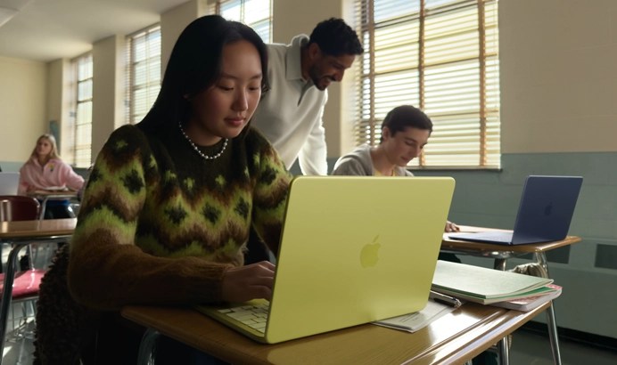 A student uses MacBook Neo, citrus color, unplugged in a classroom setting