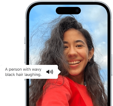 iPhone 15 showing Voiceover feature announcing the picture information: a person with wavy black hair laughing