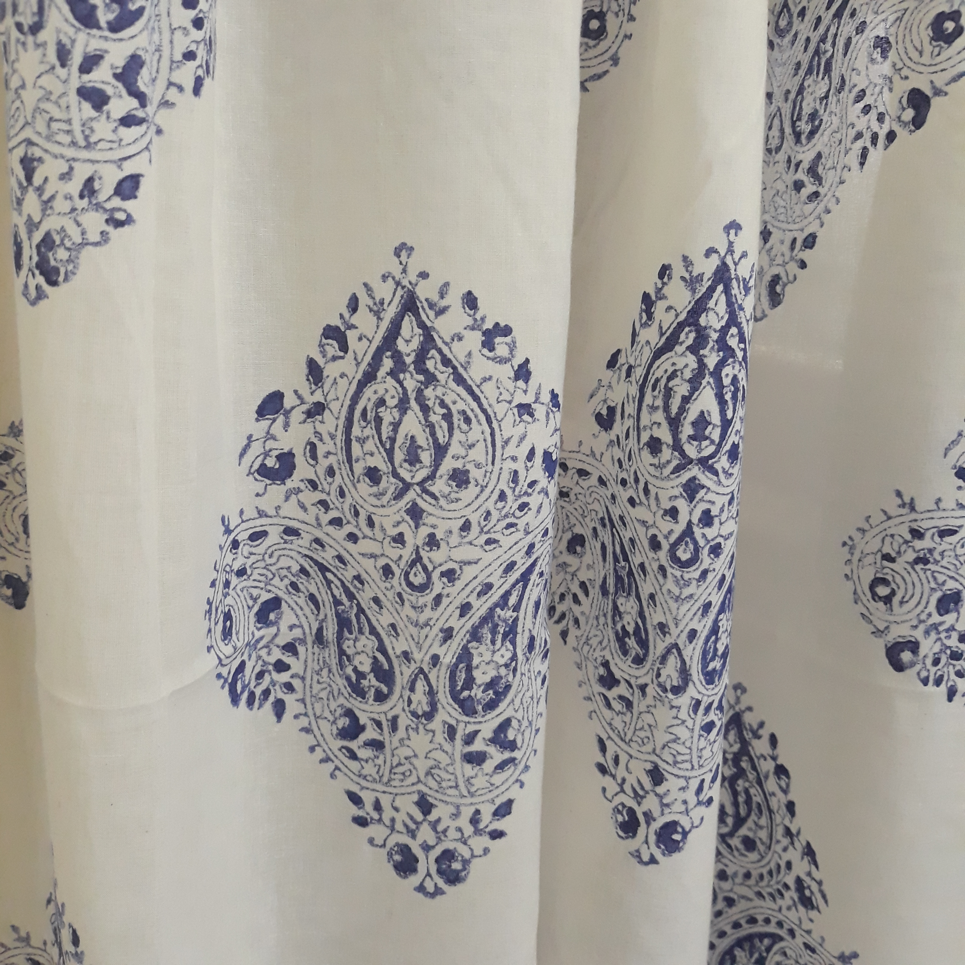 Ethnic motifs block printed in blue on a sheer decorative cotton window curtain
