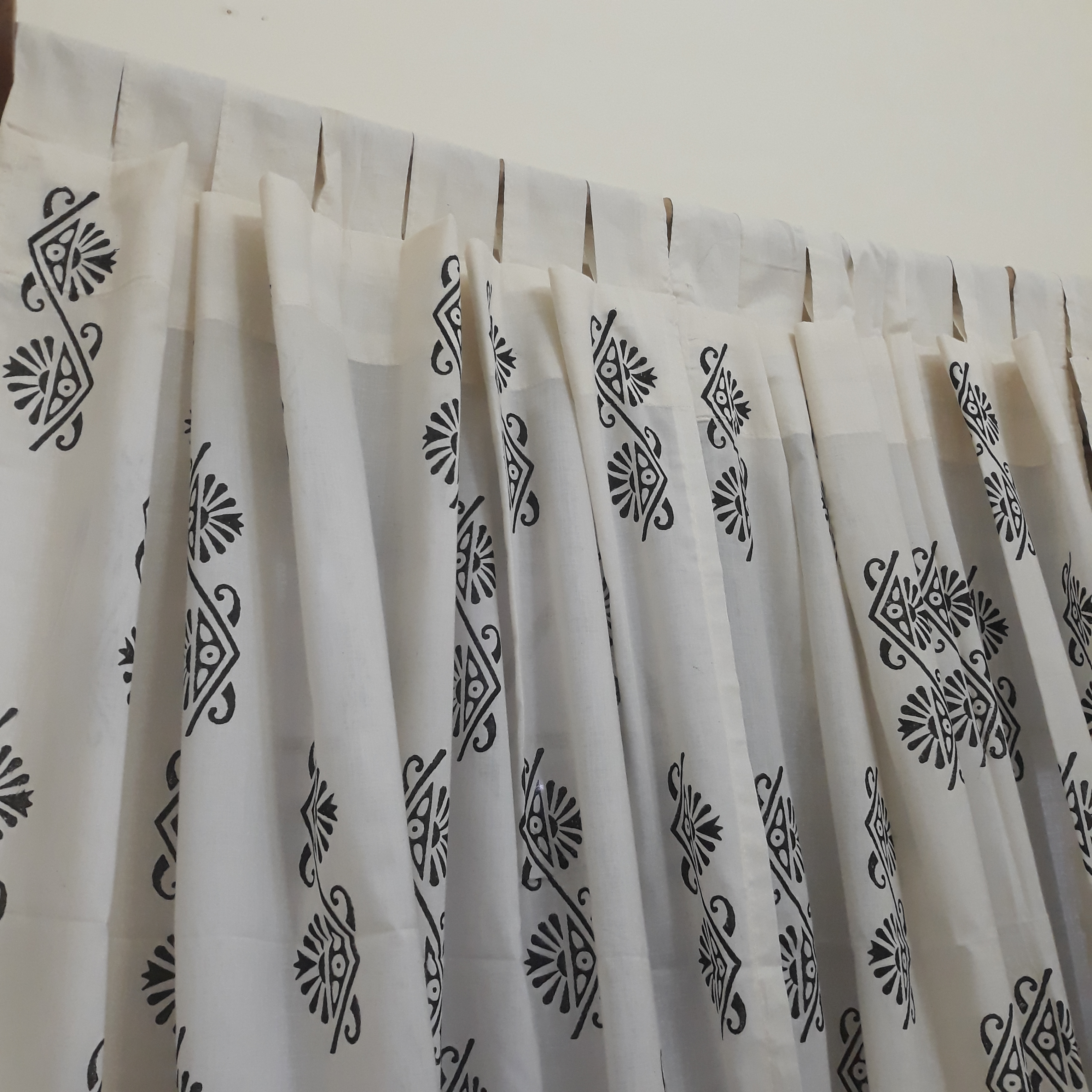 Loops tailored on a sheer cotton window curtain with ethnic motifs
