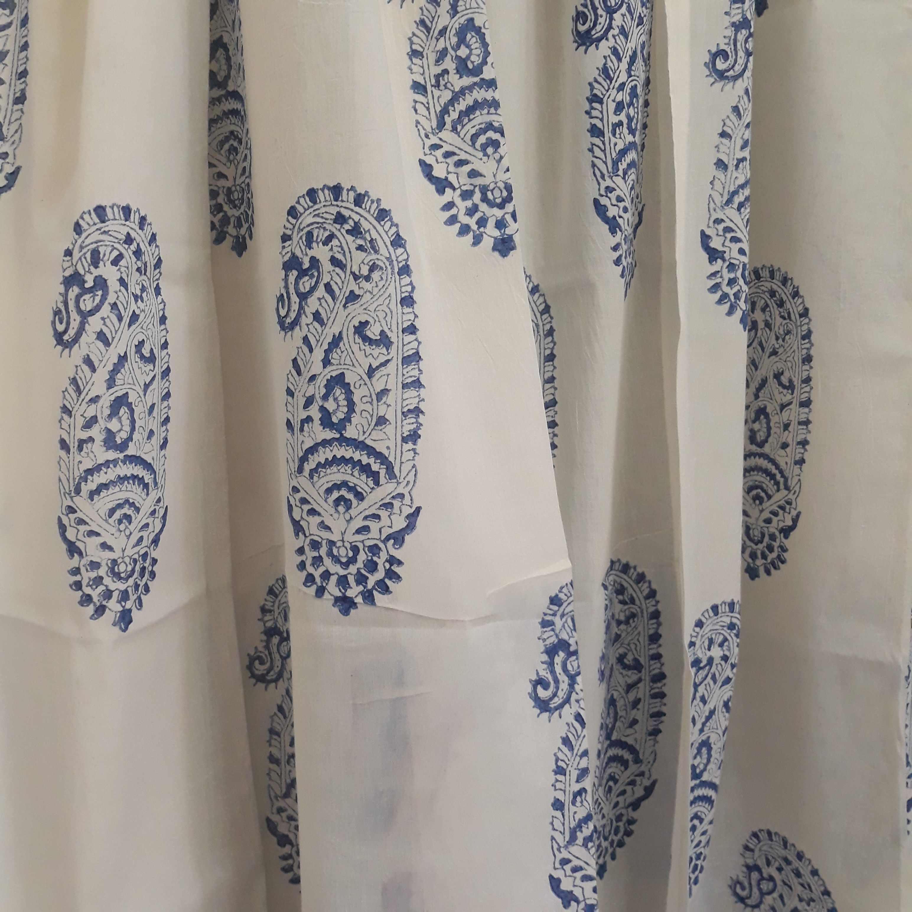 Blue paisley block printed on a sheer white cotton window curtain