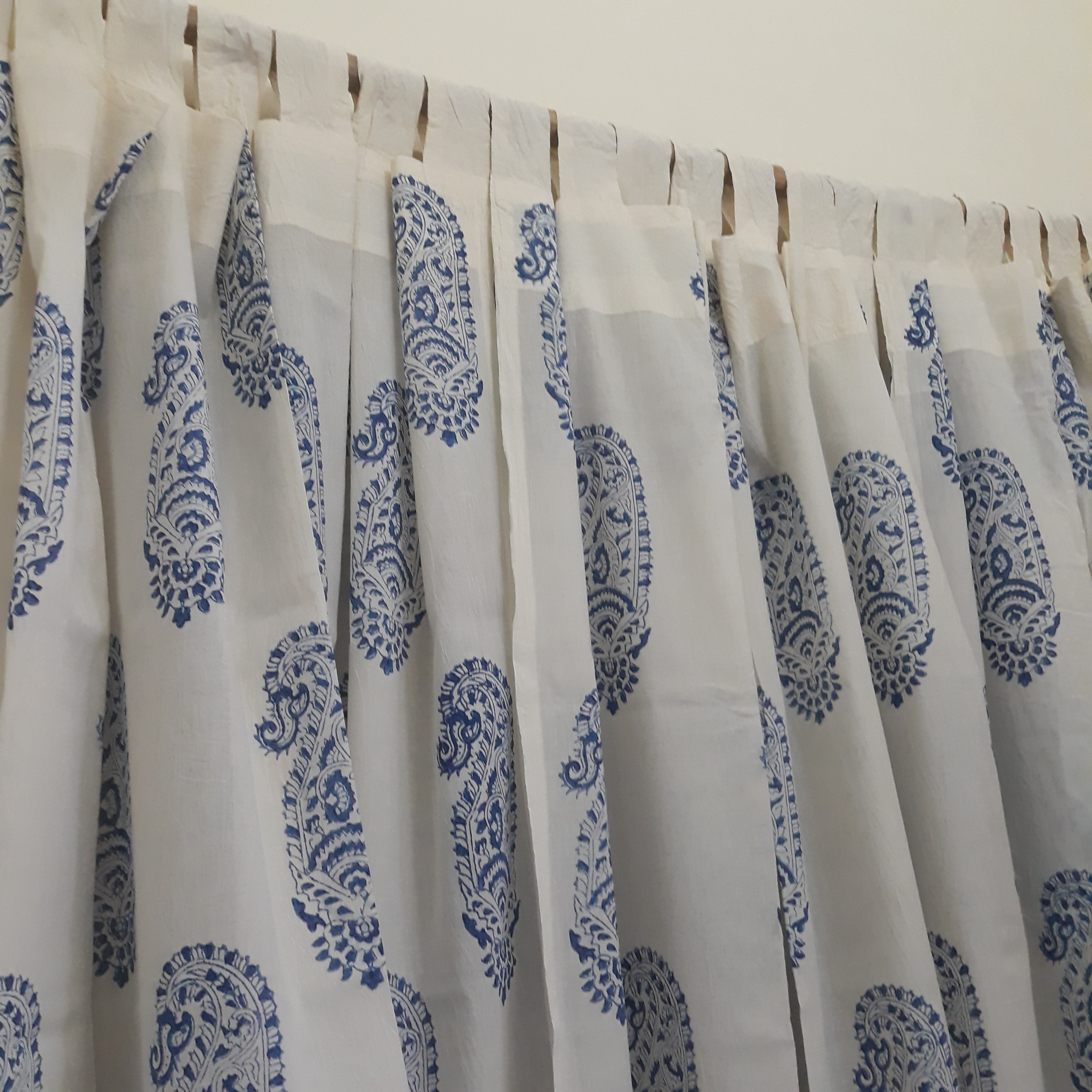 loops tailored on a decorative sheer white cotton window curtain