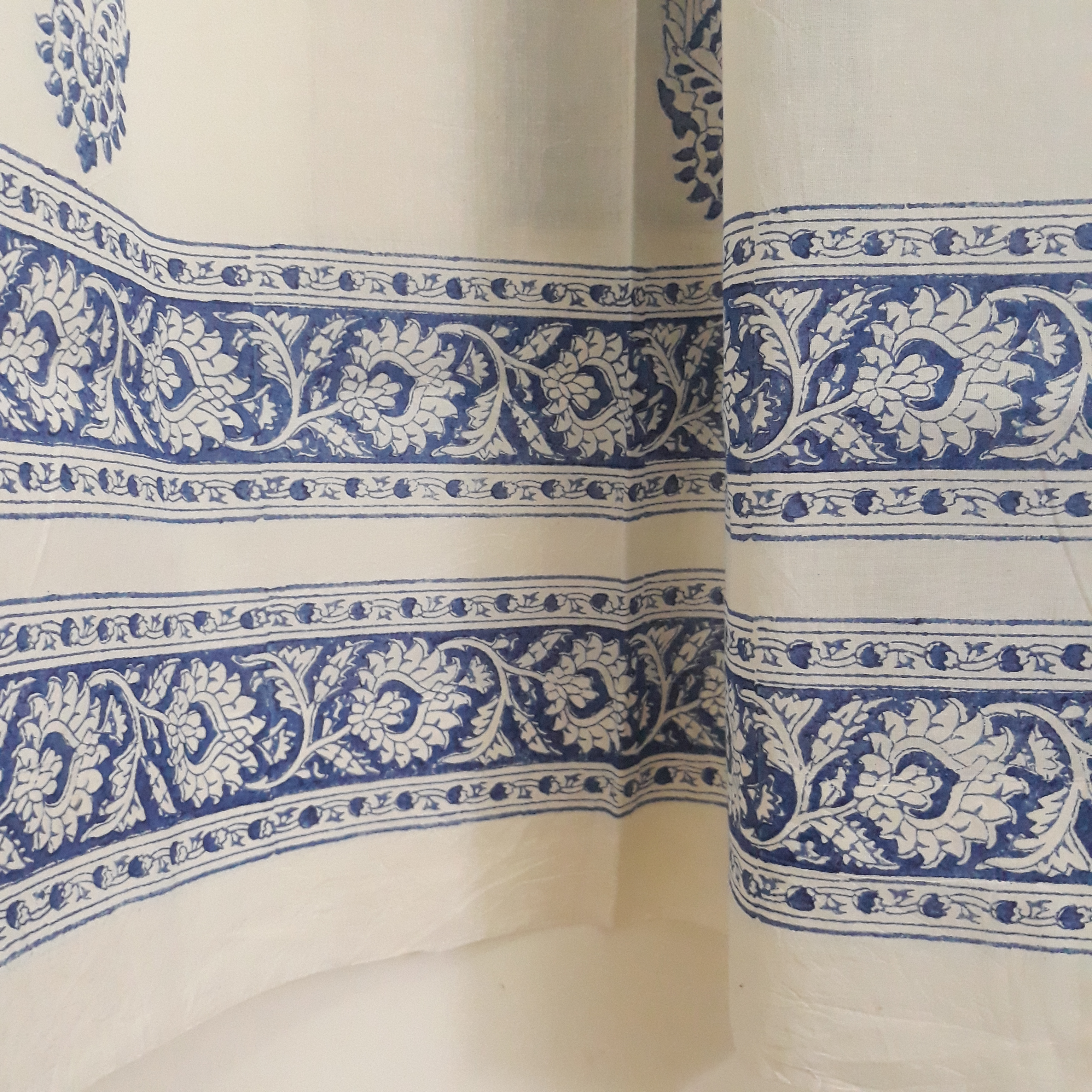 ethnic block prints on the border of a sheer white cotton window curtain for living rooms
