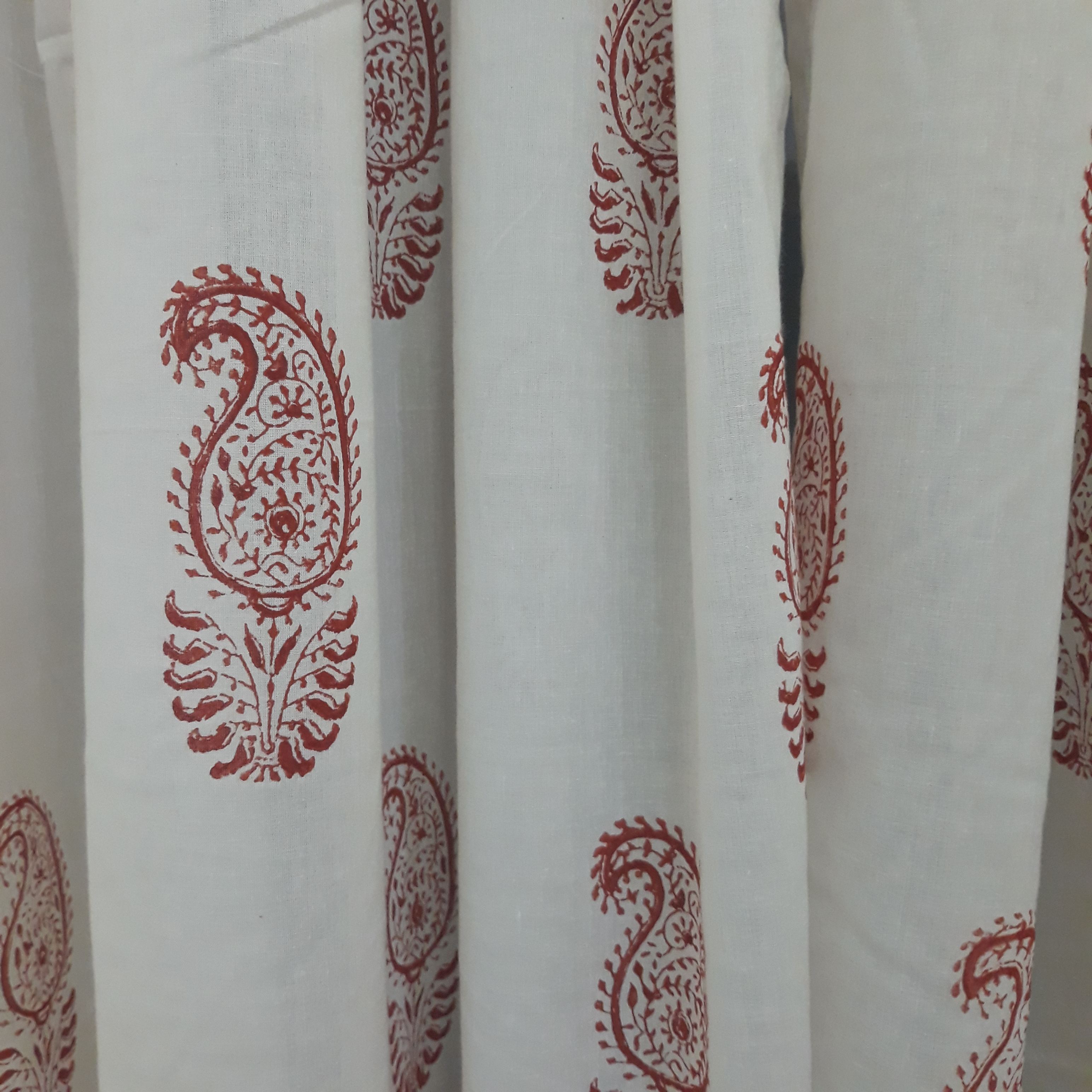 Red paisleys block printed on a sheer cotton decorative window curtain for living rooms