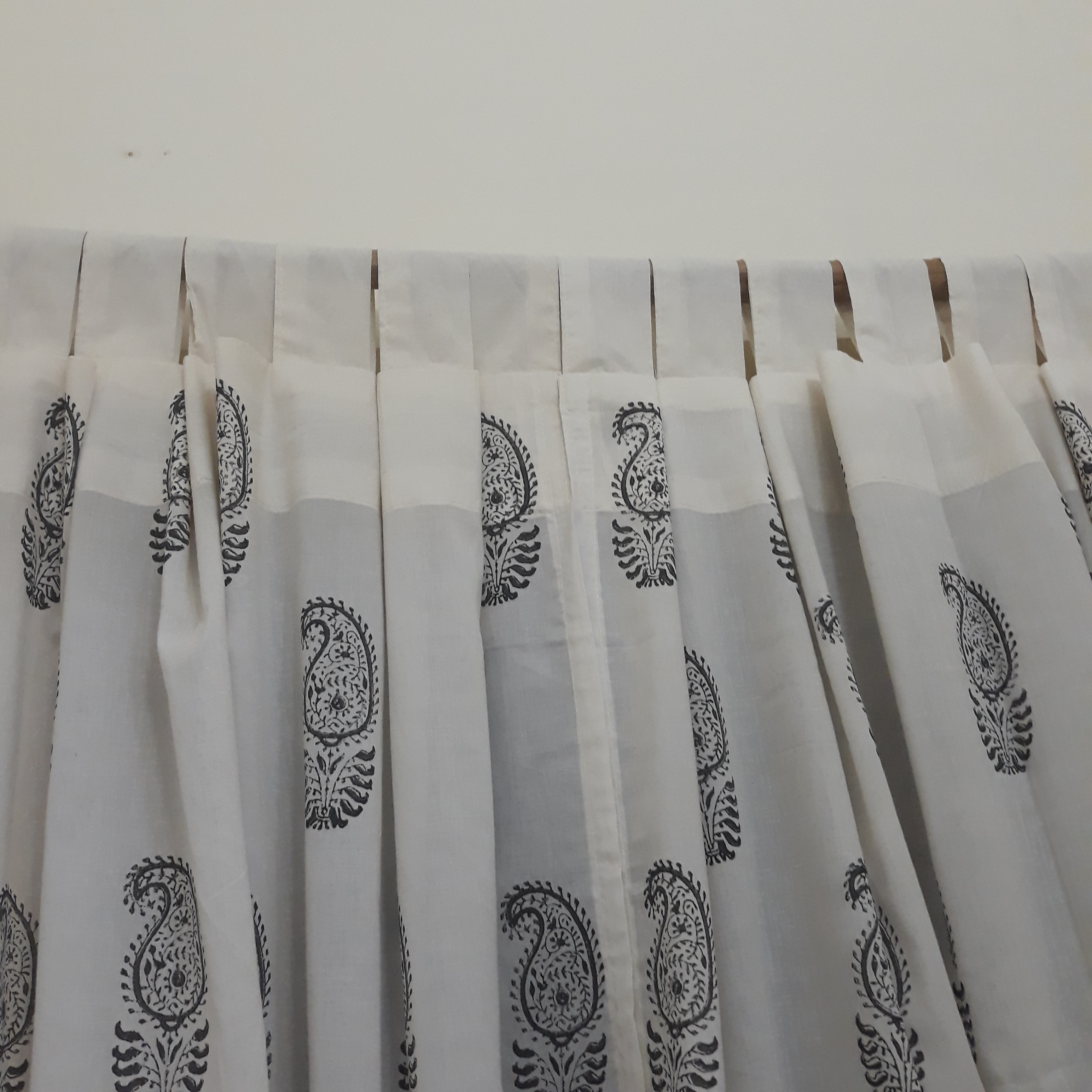 tailored loops on a sheer white block printed cotton curtain