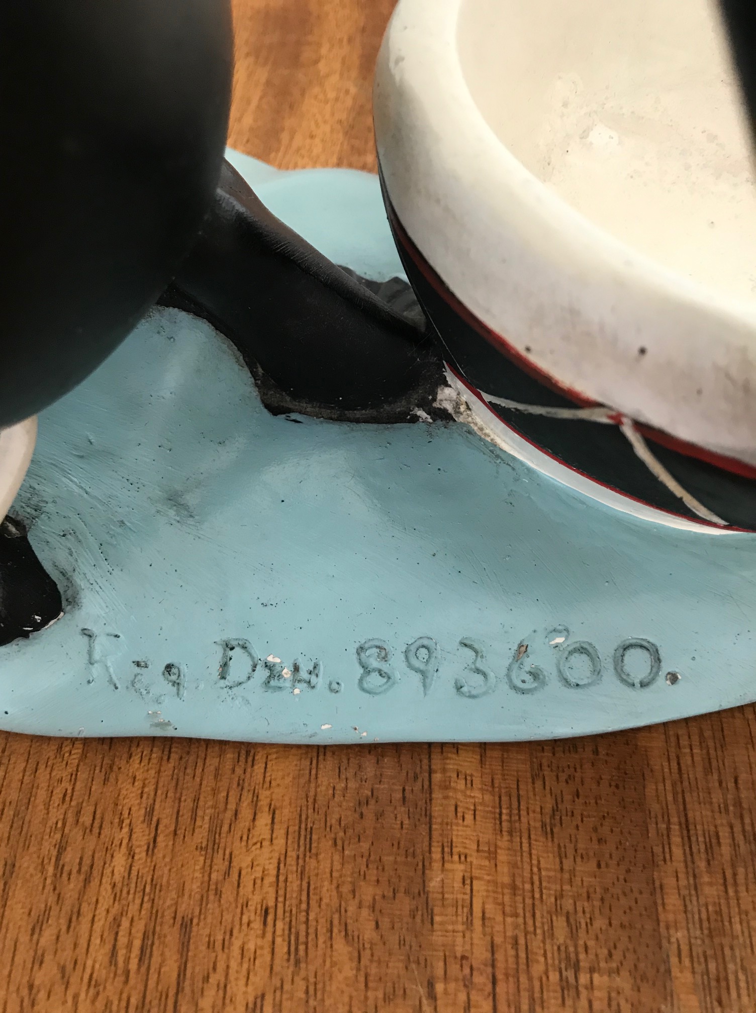 Close up of base of figurine with 893600 written