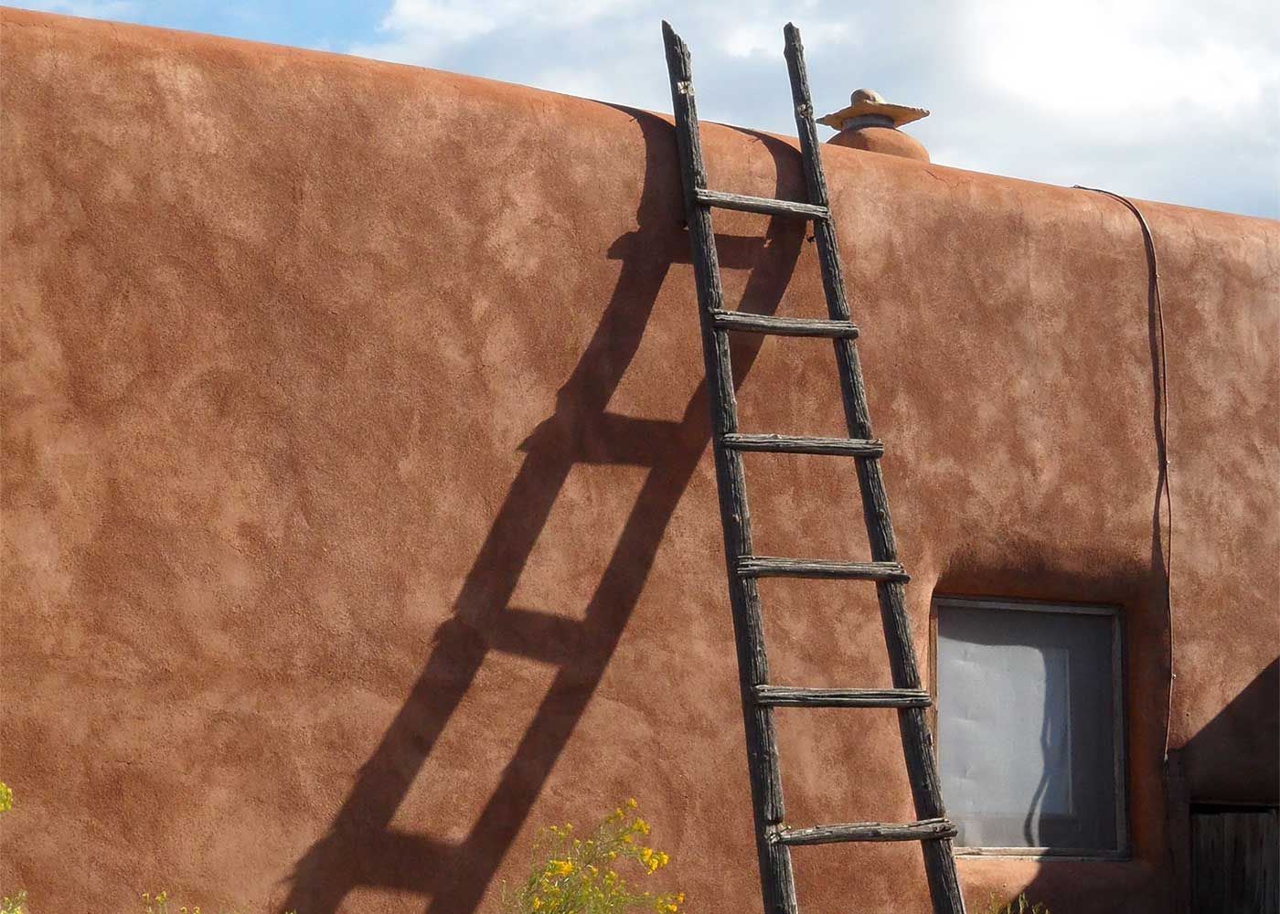 Ladder leaning on an wall of an adobe structure