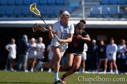 IMG_8883 Ally Mastroianni (12) looks for an open pass as UNC women's lacrosse takes on Maryland at Dorrance Field in Chapel Hill on Saturday, February 22. (Dakota Moyer/Chapelboro.com)