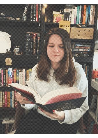 girl reads & closes book gif