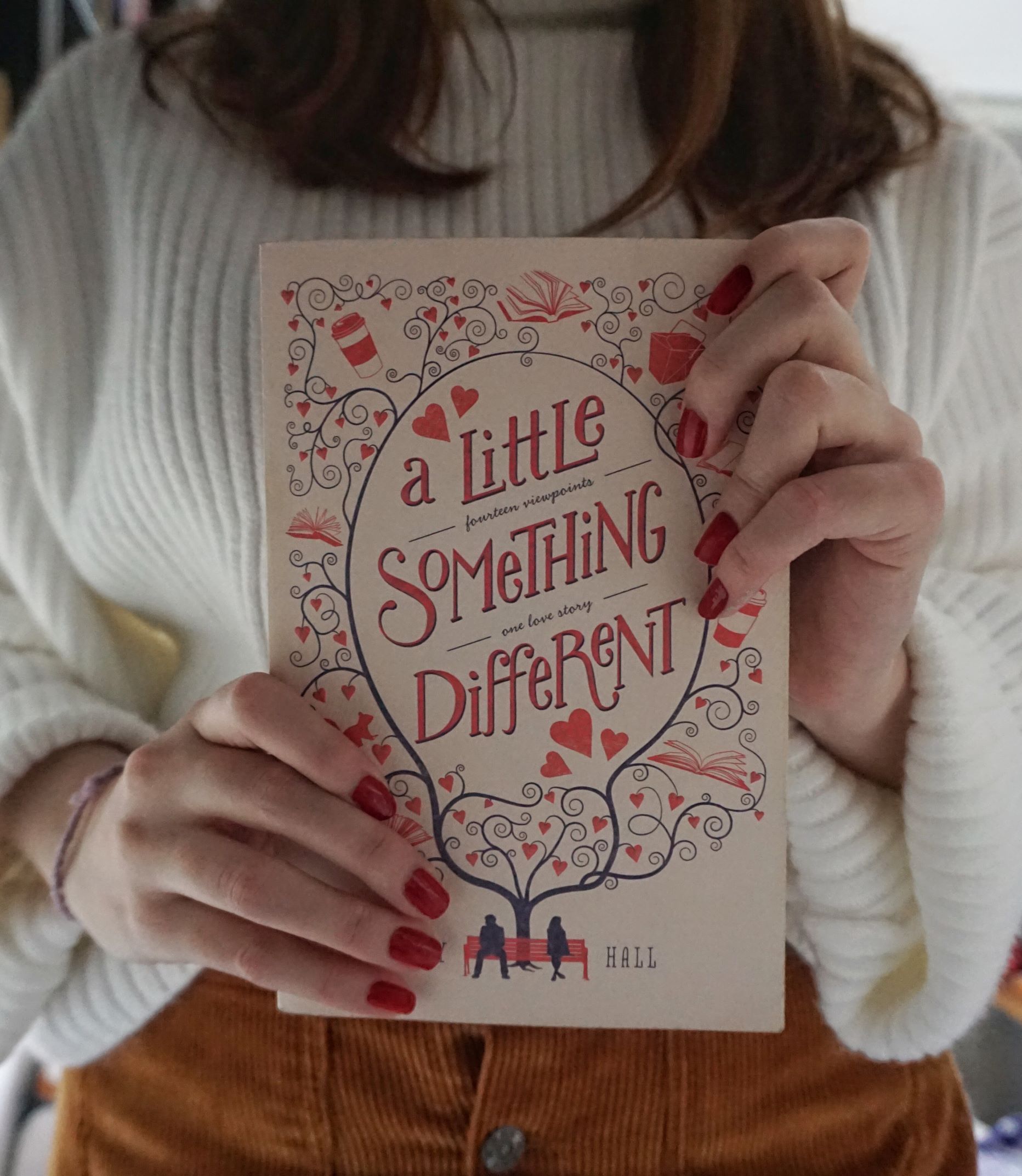 girl dressed in brown skirt and jumper, holding 'A Little Something Different' by Sandy Hall