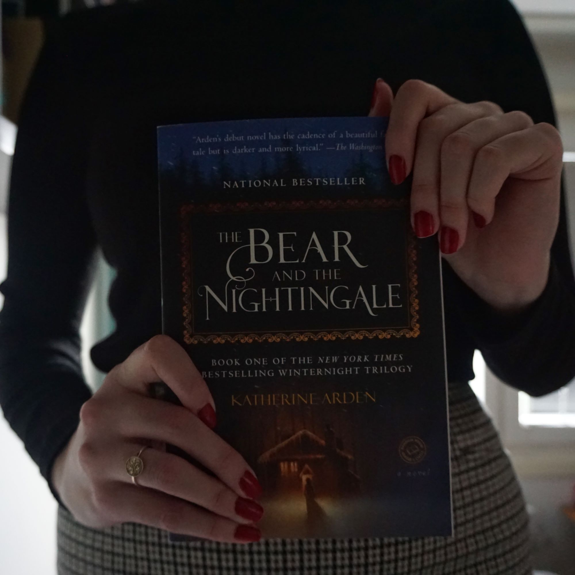 girl holds book 'The Bear and the Nightingale'
