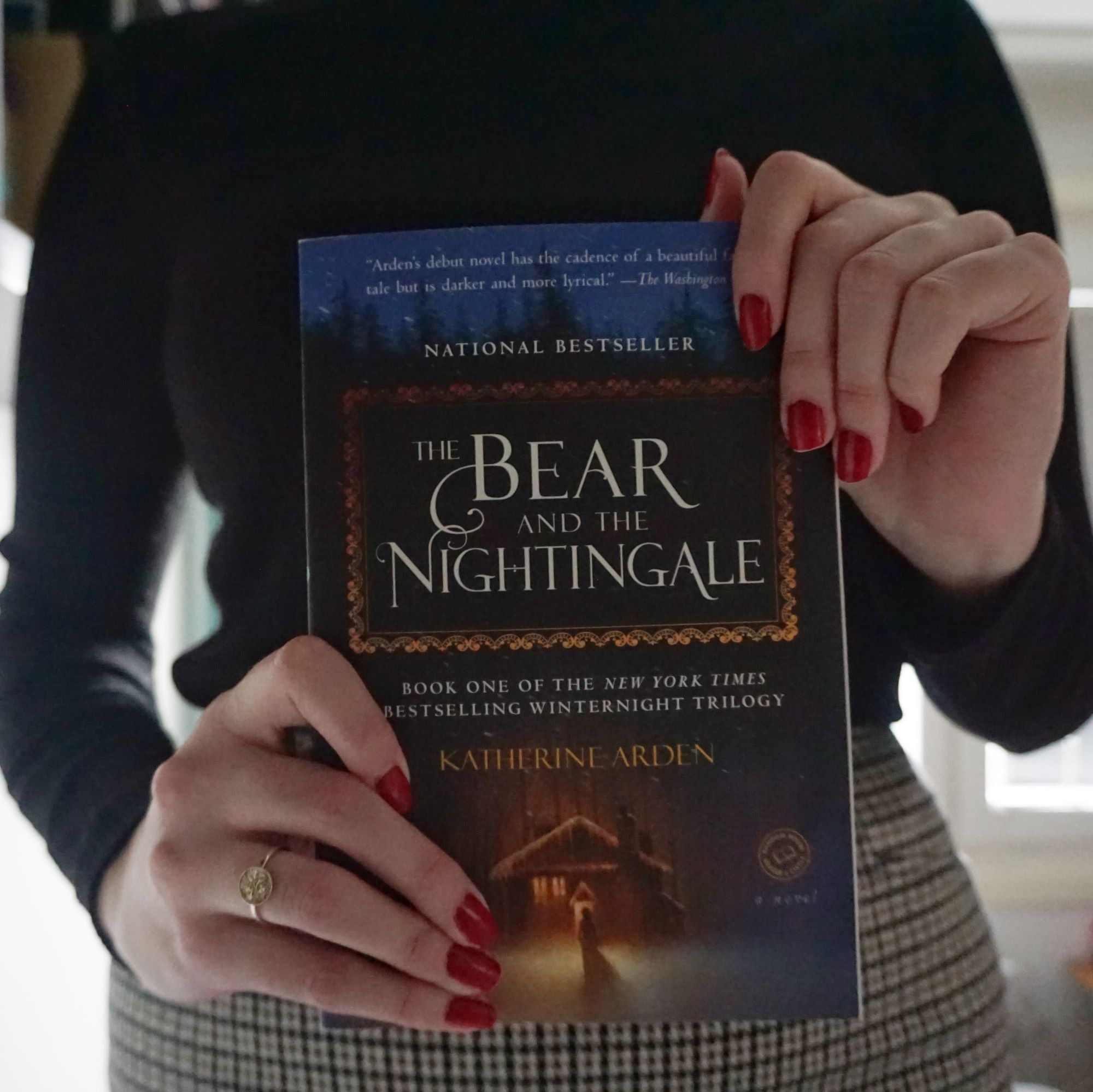 girl holds book 'The Bear and the Nightingale'