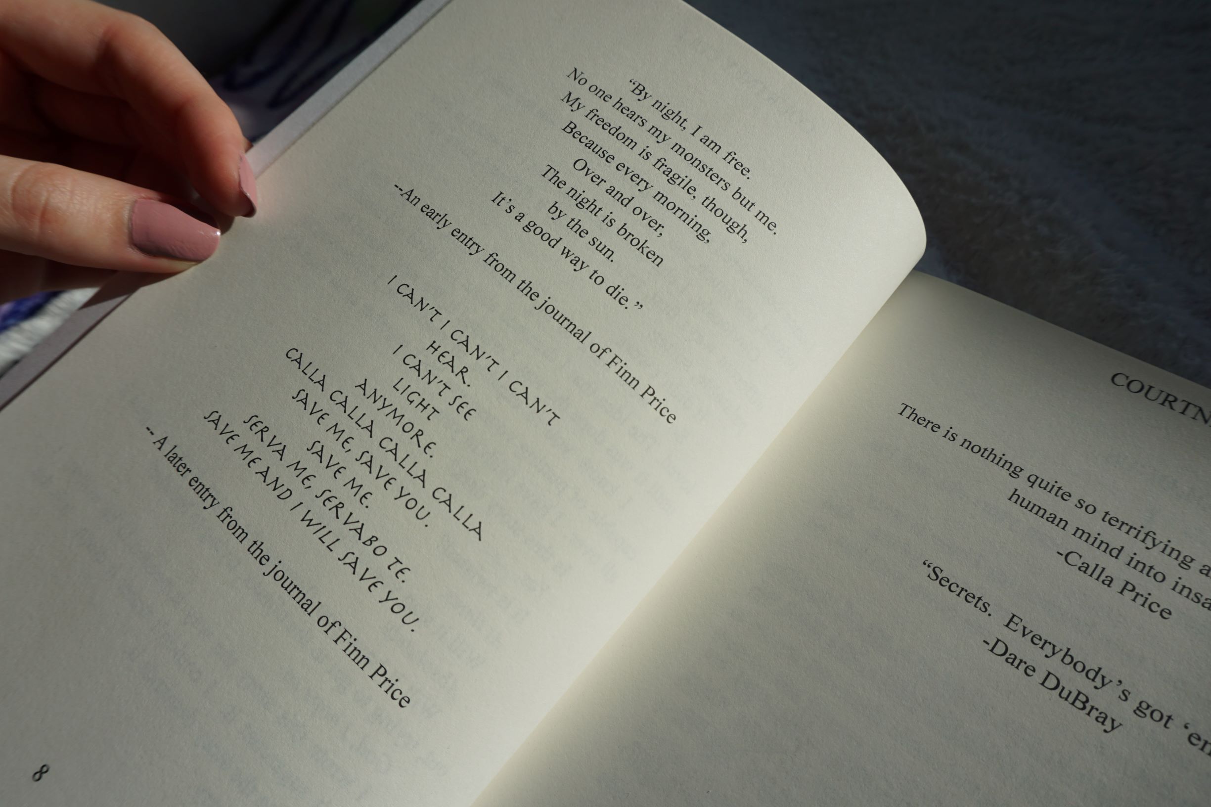 A copy of Nocte by Courtney Cole is held open by a female hand with nails painted nude. The book is opened to a page of characters' quotes in Nocte