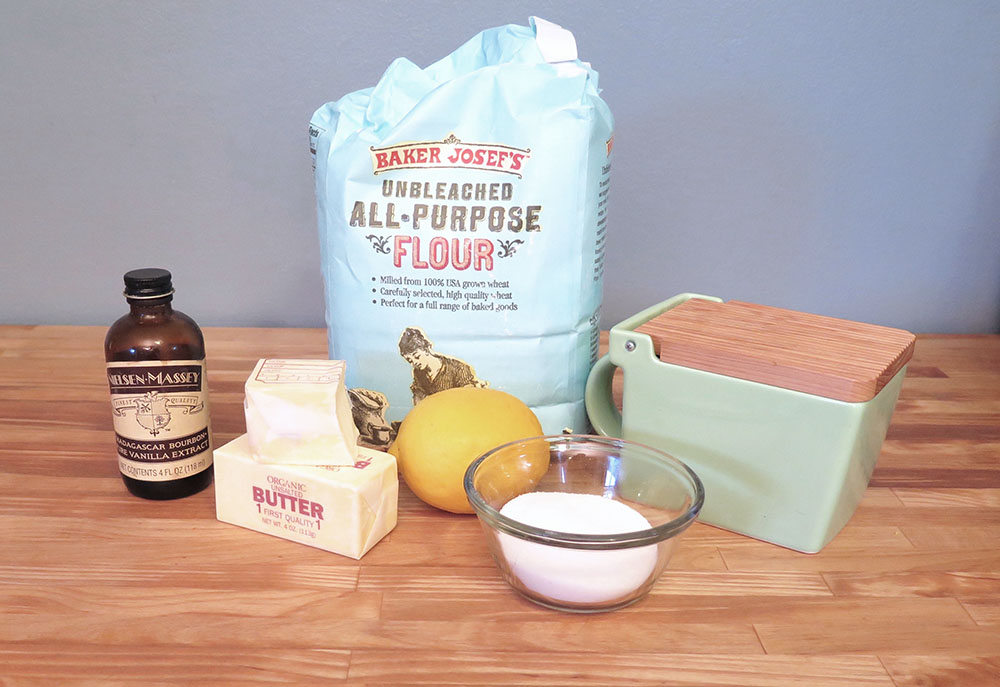 the ingredients needed for meyer lemon shortbread: flour, sugar, salt, butter, vanilla, one lemon.