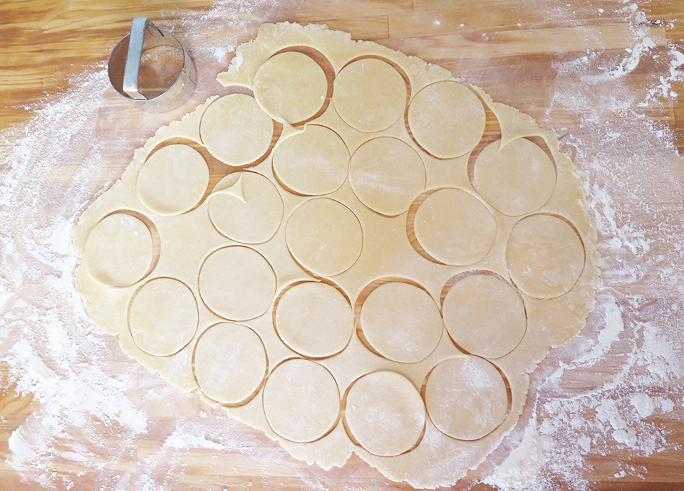 Cutting out circles of dough for the cookies.