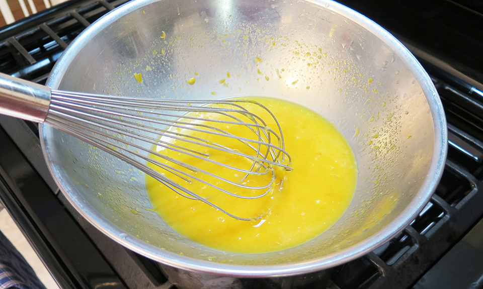 Lemon curd cooking on a double boiler