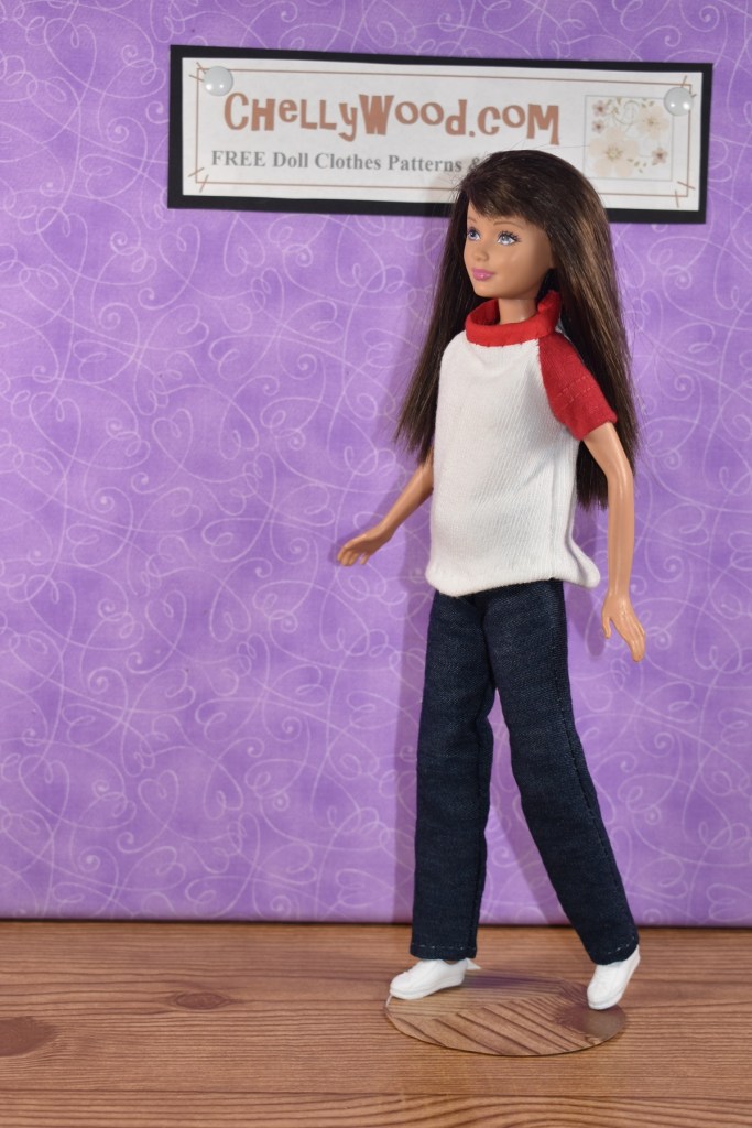 The image shows a Mattel Skipper doll wearing handmade doll clothes which were designed to fit dolls with body types like the Mattel Skipper doll. The doll clothes shown on this doll include a raglan-sleeved T-shirt and jeans. Click on the link in the caption to access all the free printable PDF sewing patterns and tutorial videos you'll need to help you make these doll clothes for your Skipper-sized dolls.