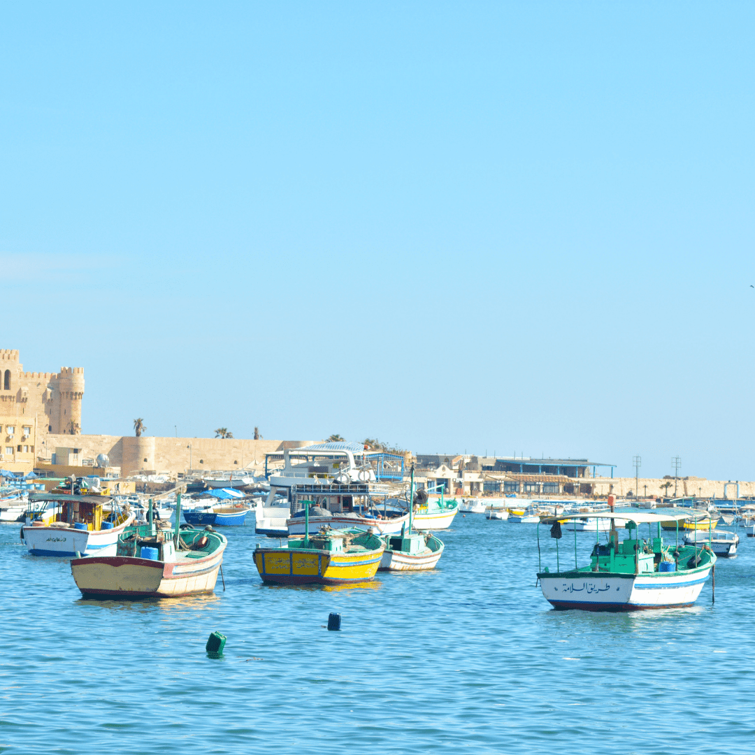 Boats approaching the Mediterranean shore of Alexandria, Egypt