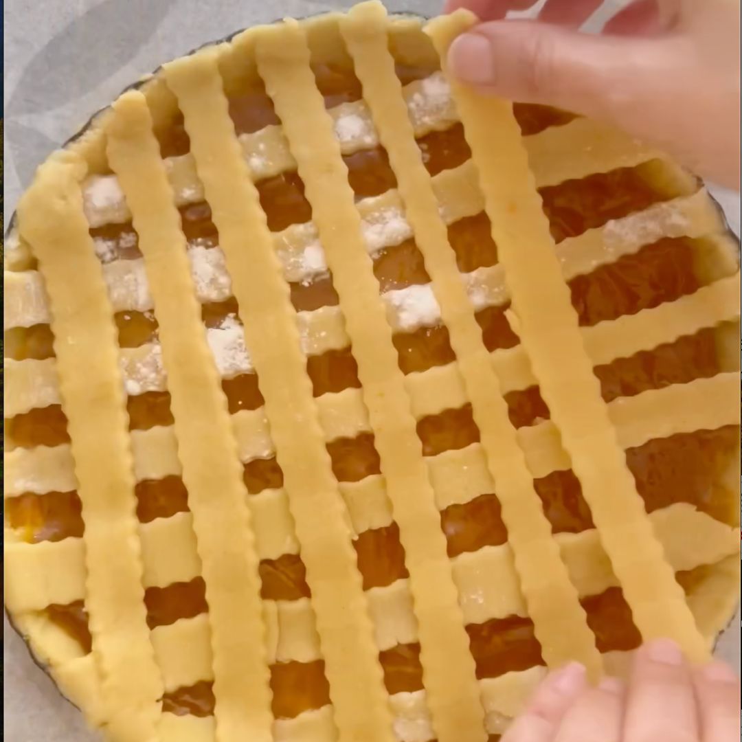 Lay the dough ribbon in a crisscross to create a decorative pattern.