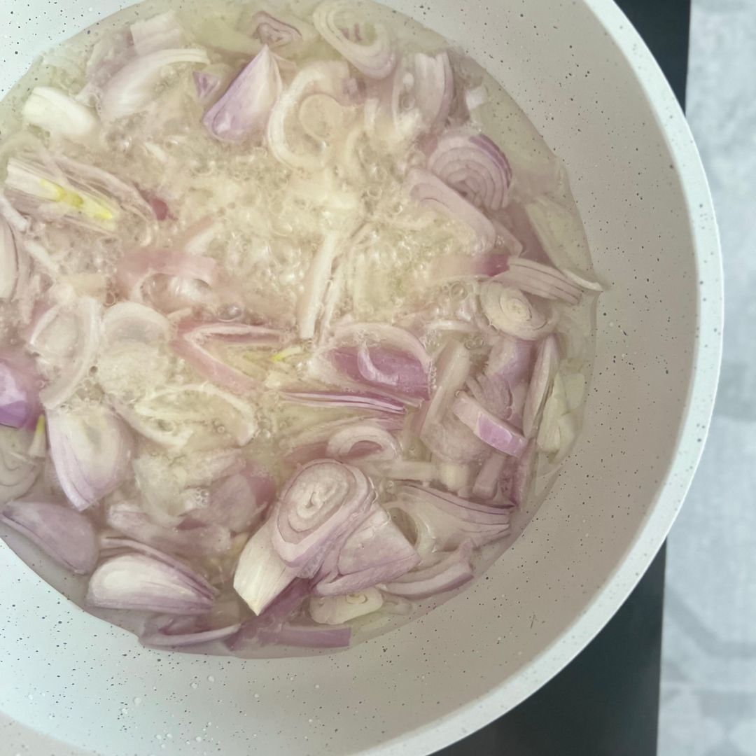 Fry shallots in warm to touch oil.