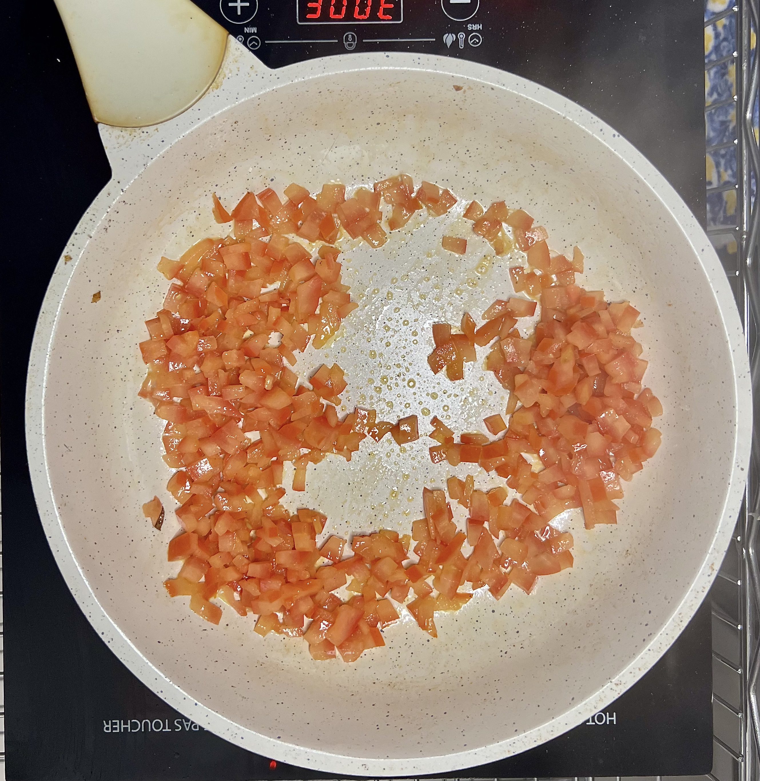 Step 2; Sautee the tomato until it absorbs its pan juices.