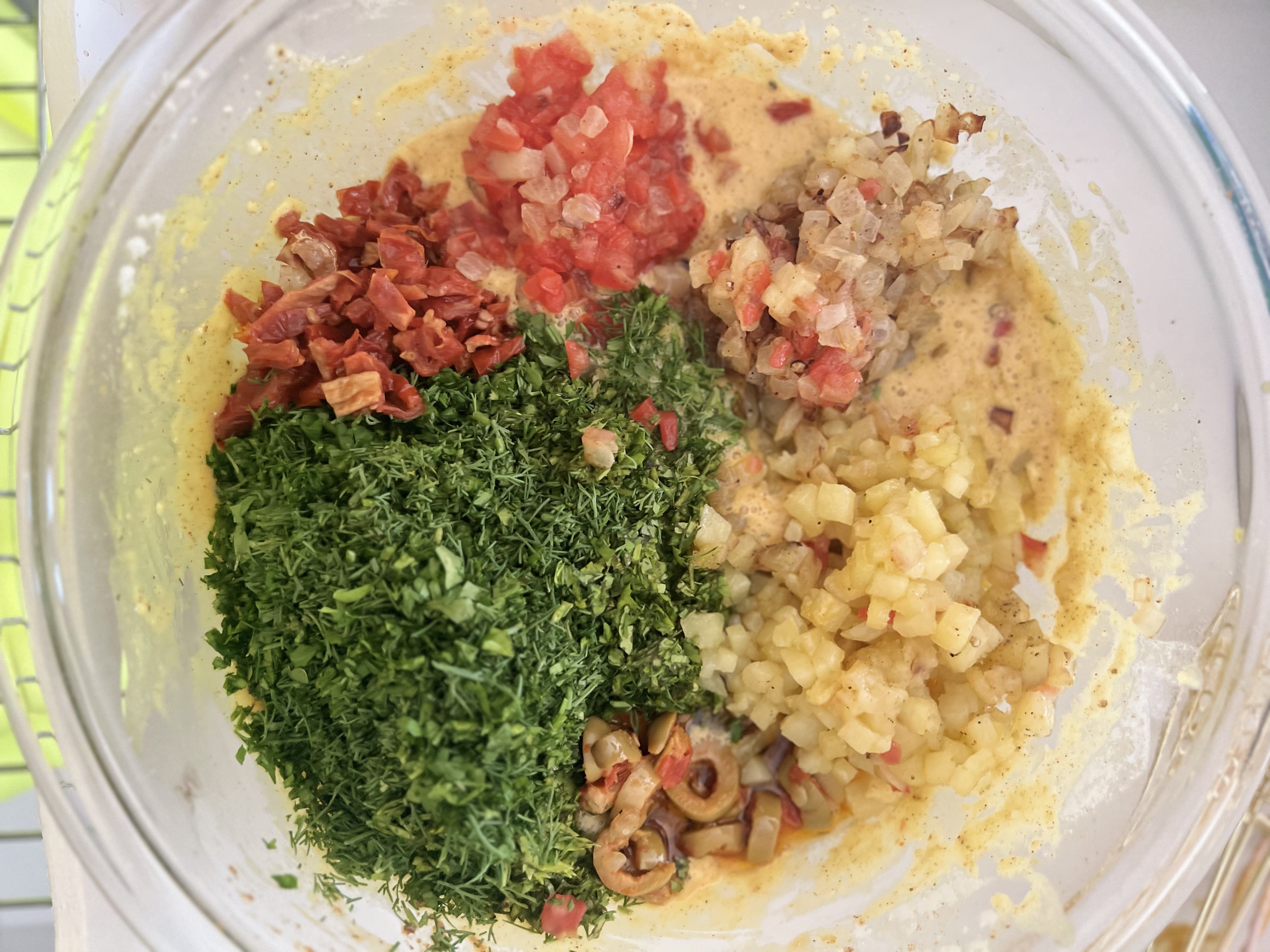 Step 9: Add the sautéed vegetables, fresh herbs, pickled olives and sun-dried tomatoes, if using.