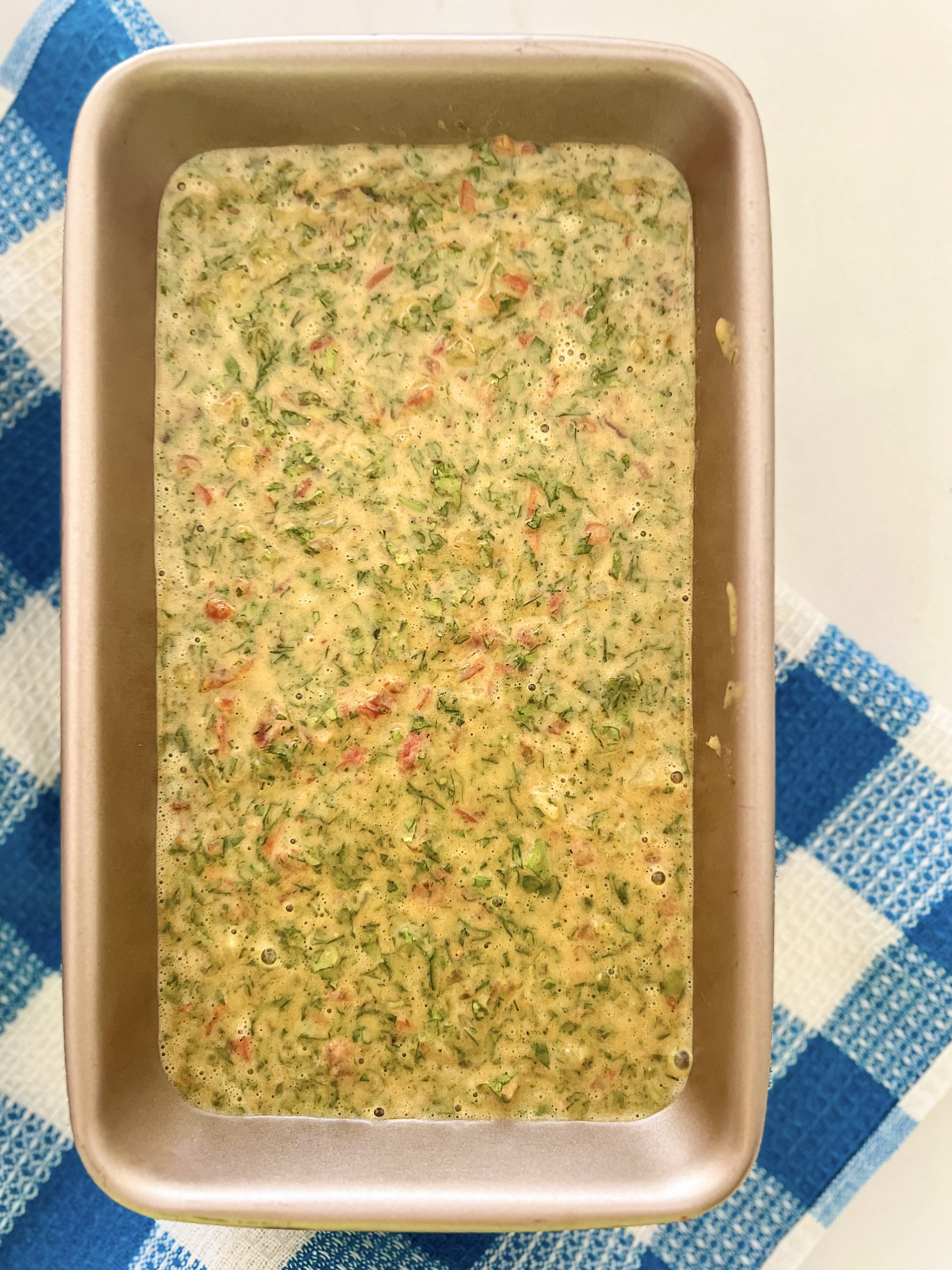 Step 11: Transfer the batter to a greased baking pan and bake until puffy, golden on the edges, and baked through.