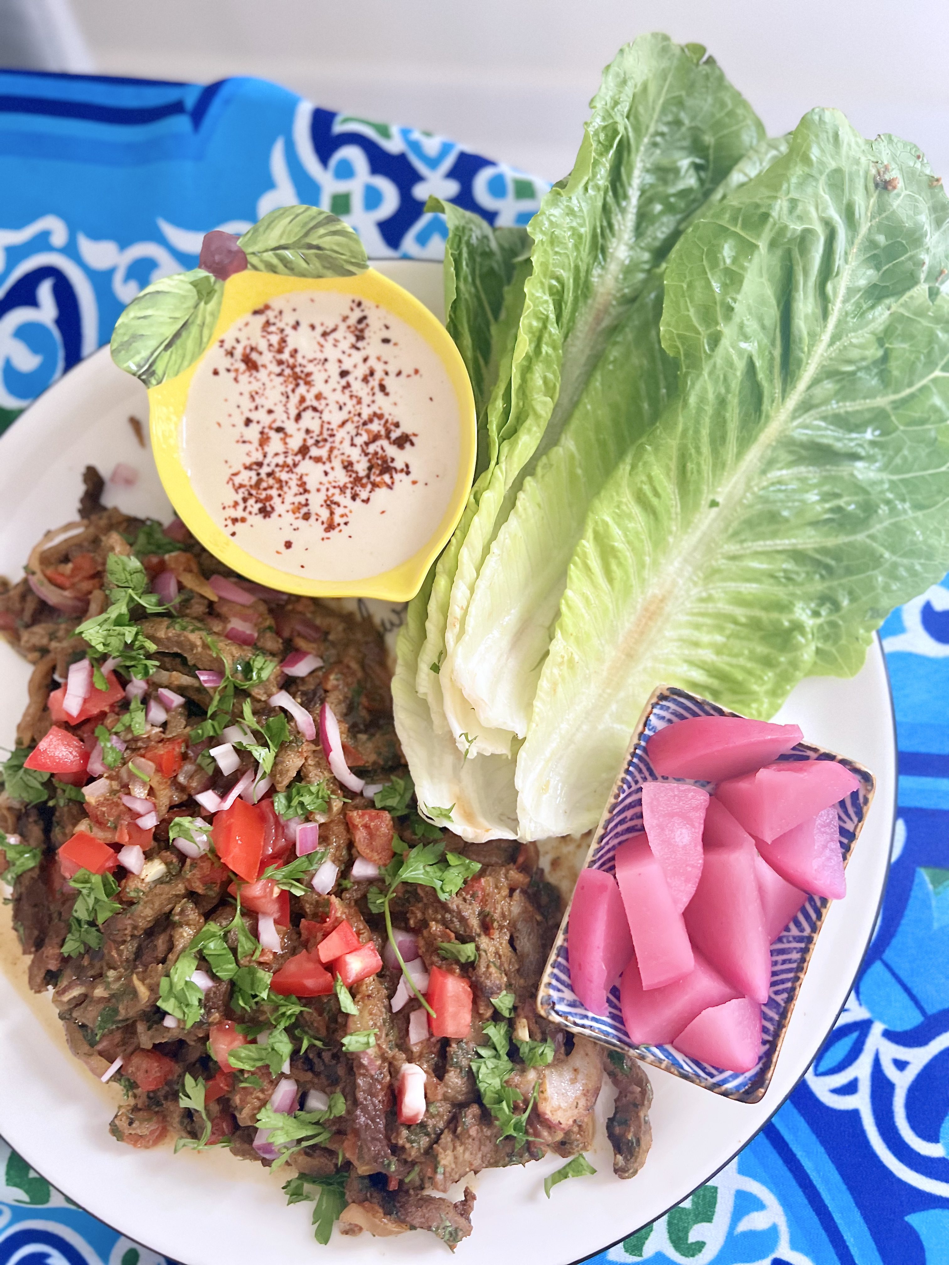 Beef Shawarma served with lettuce, pickles and tahini sauce