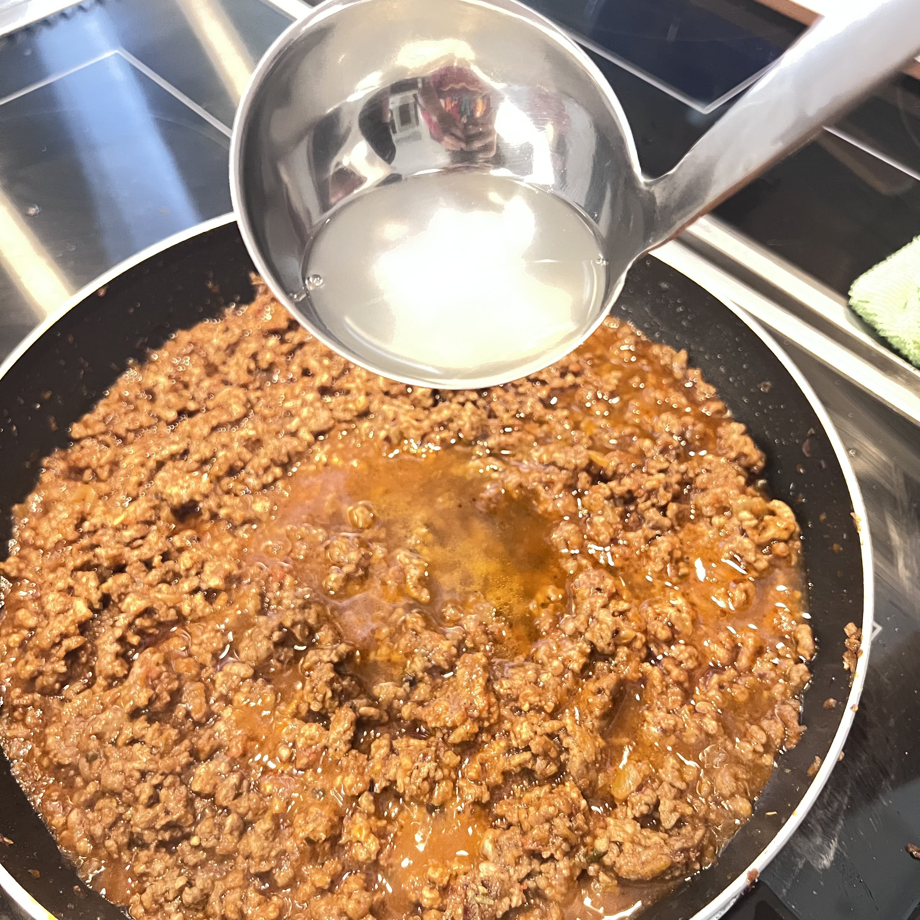 In case the meat sauce runs dry, add a paddle of pasta water and let the meat sauce simmer and thicken over low heat.