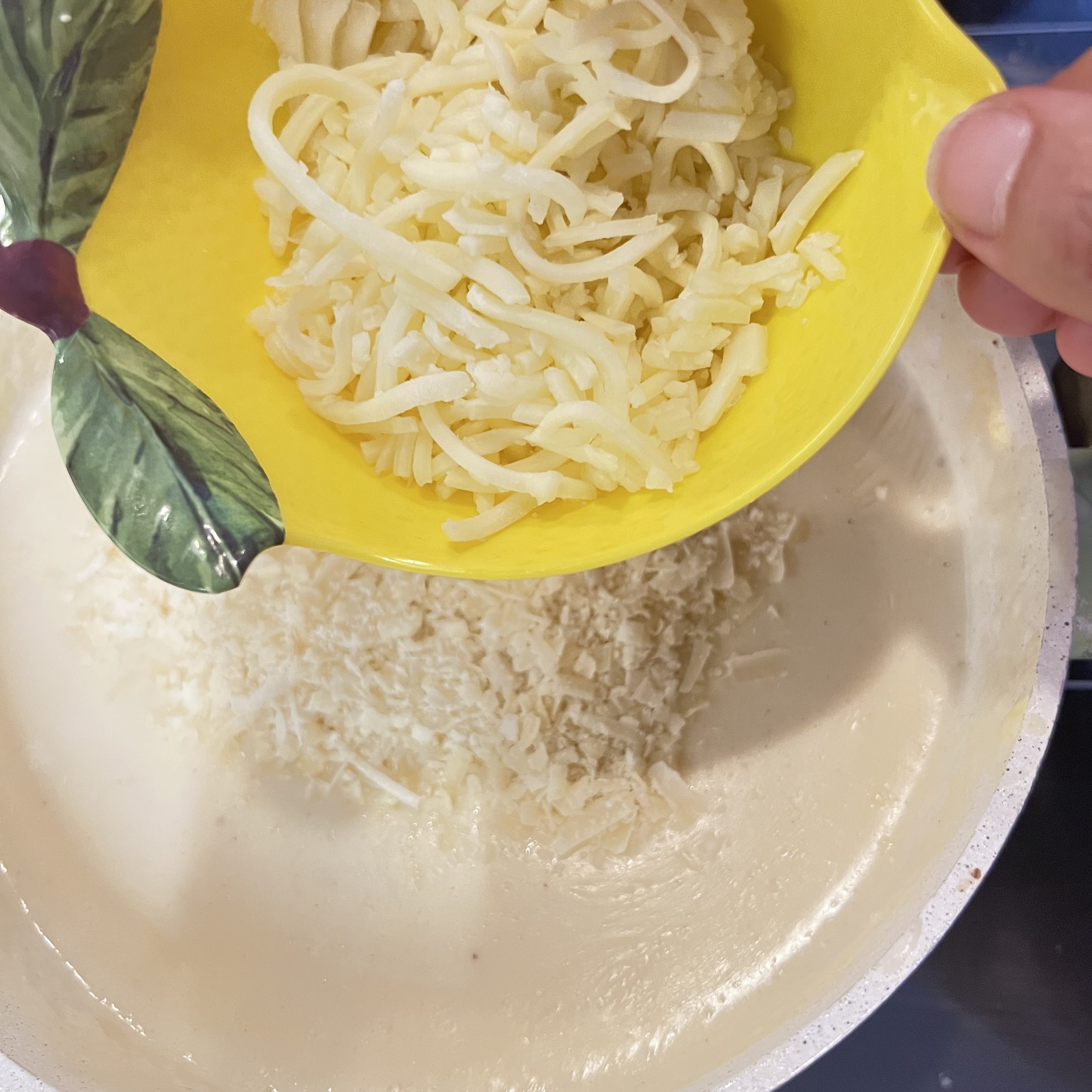 Add mozzarella cheese to the white sauce.