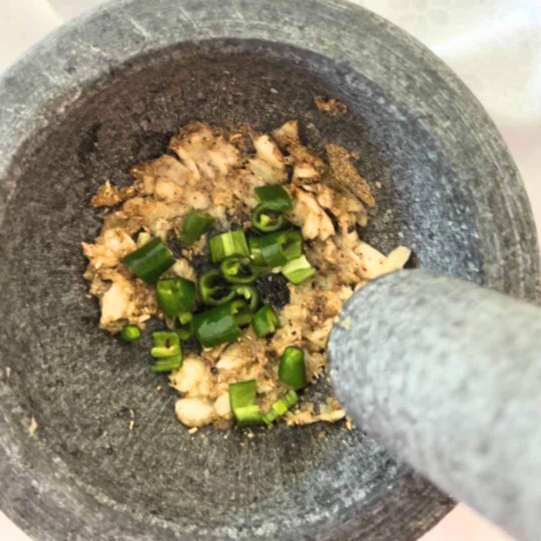 2- In a mortar and pestle, pound together garlic, spices, green chili to a smooth paste.